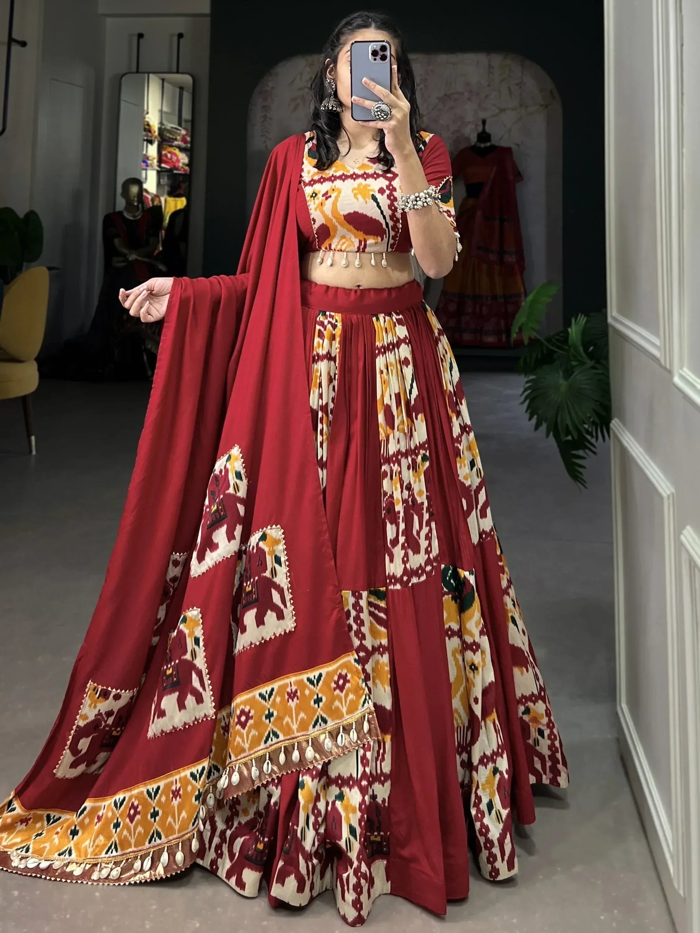 Red and cream printed lehenga choli with elephant motifs and dupatta, perfect for Indian ethnic wear