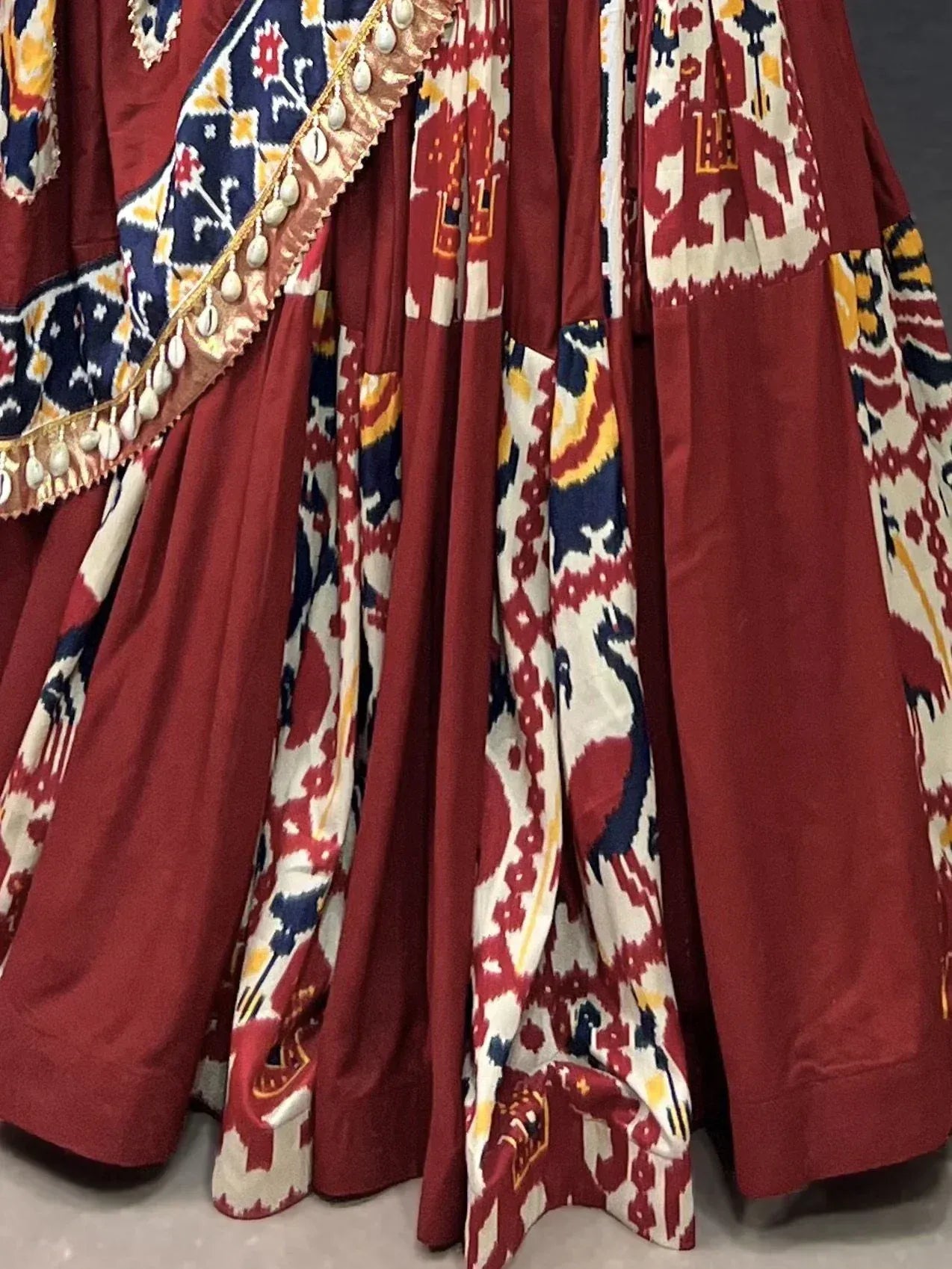 Maroon ethnic lehenga with ikat print and shell trim, perfect for Indian weddings and festivals