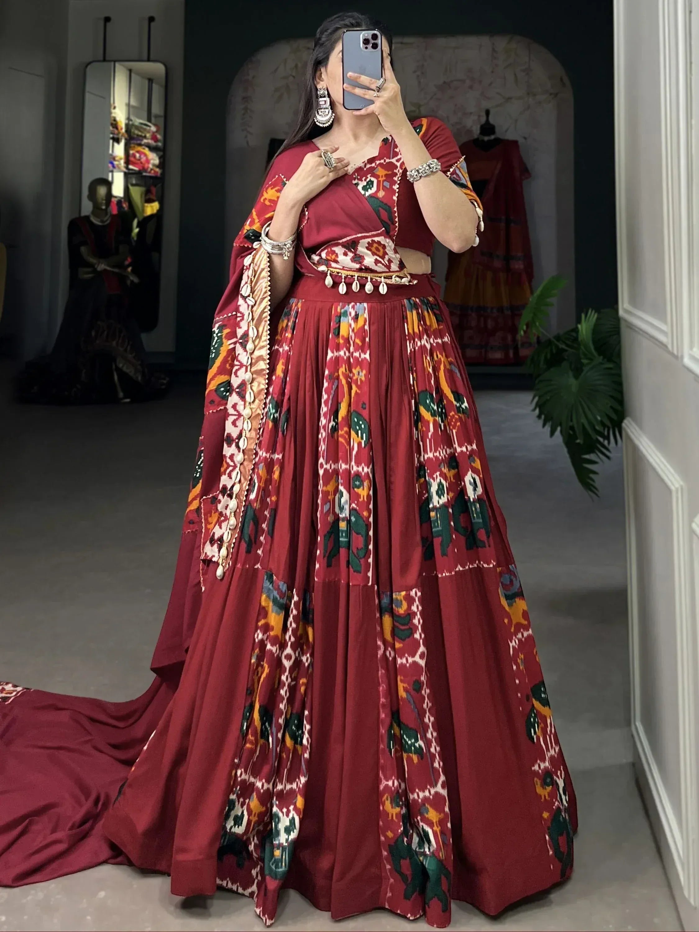 Maroon Ikat print lehenga choli with elephant motifs, dupatta, and shell embellishments for ethnic wear