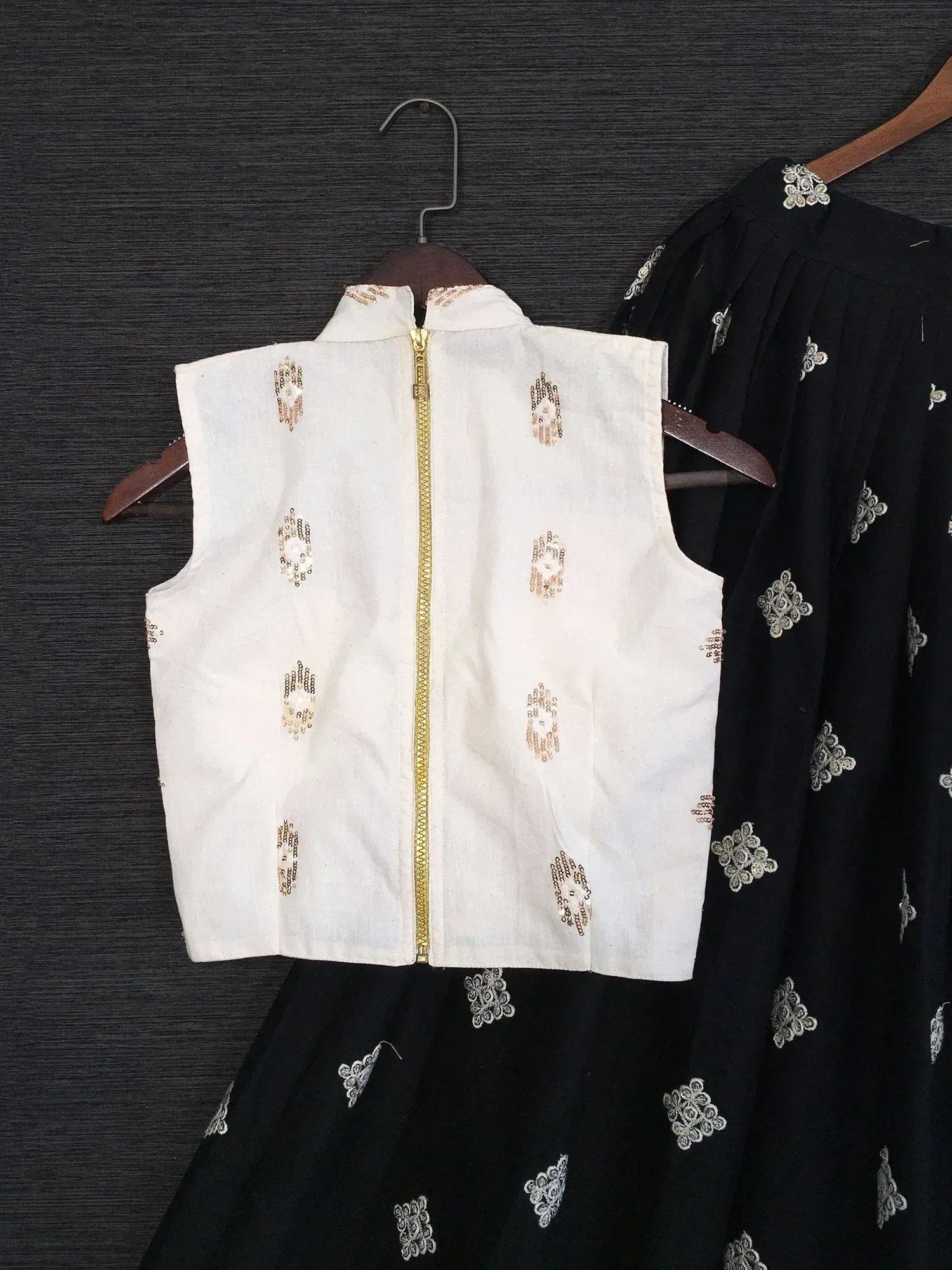 White embroidered crop top with gold zipper paired with black printed skirt, ethnic wear set