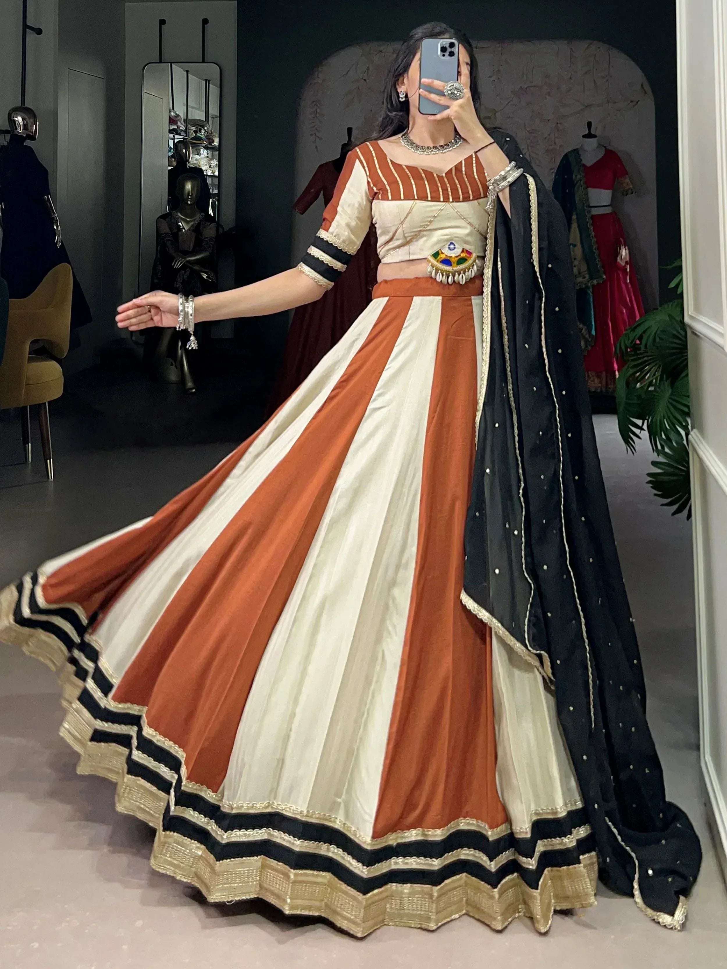Orange and cream striped lehenga choli with black dupatta, ethnic Indian wear for weddings and parties