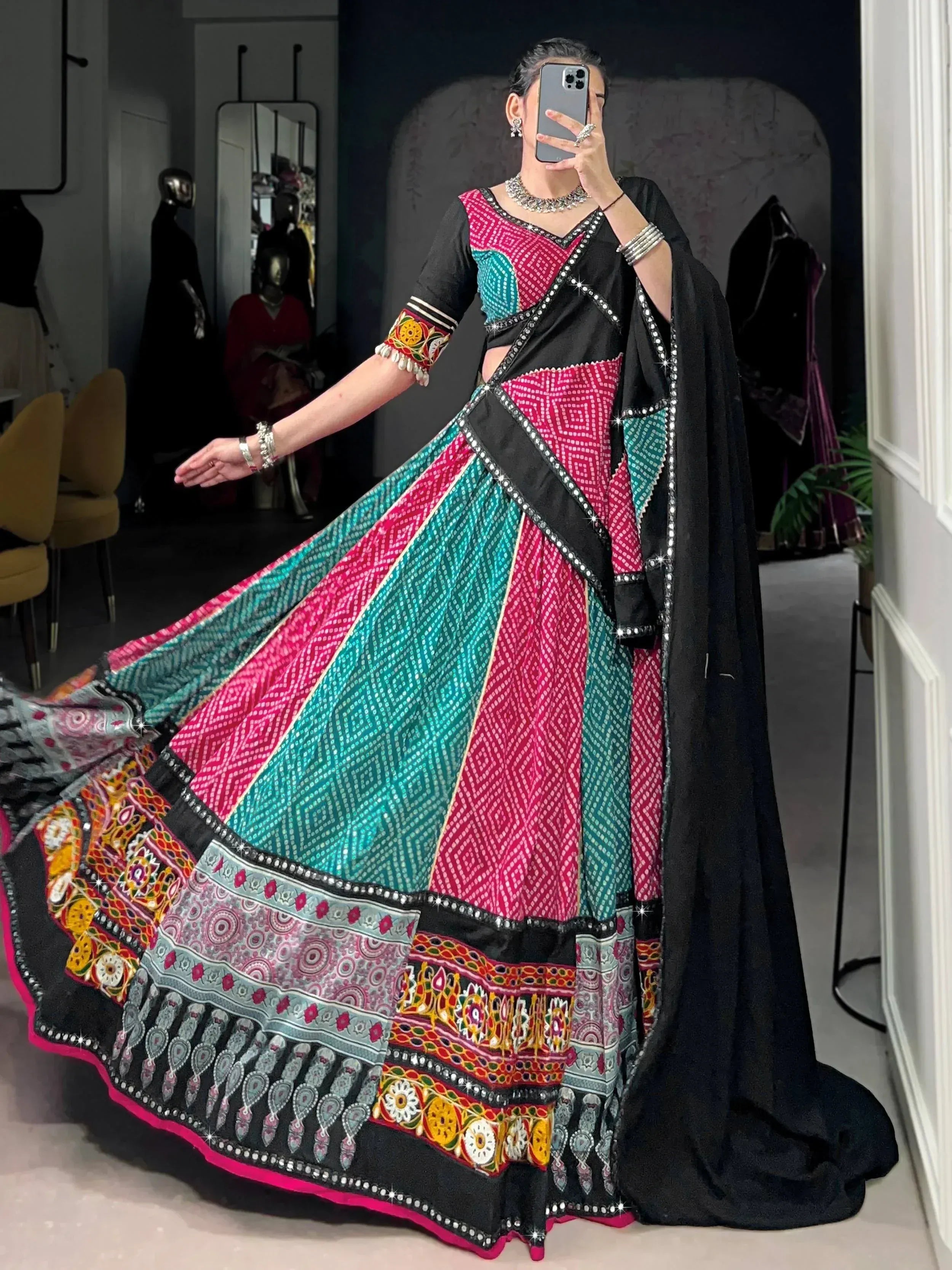 Vibrant pink and teal patchwork lehenga choli with mirror work, perfect for Indian ethnic wear occasions.