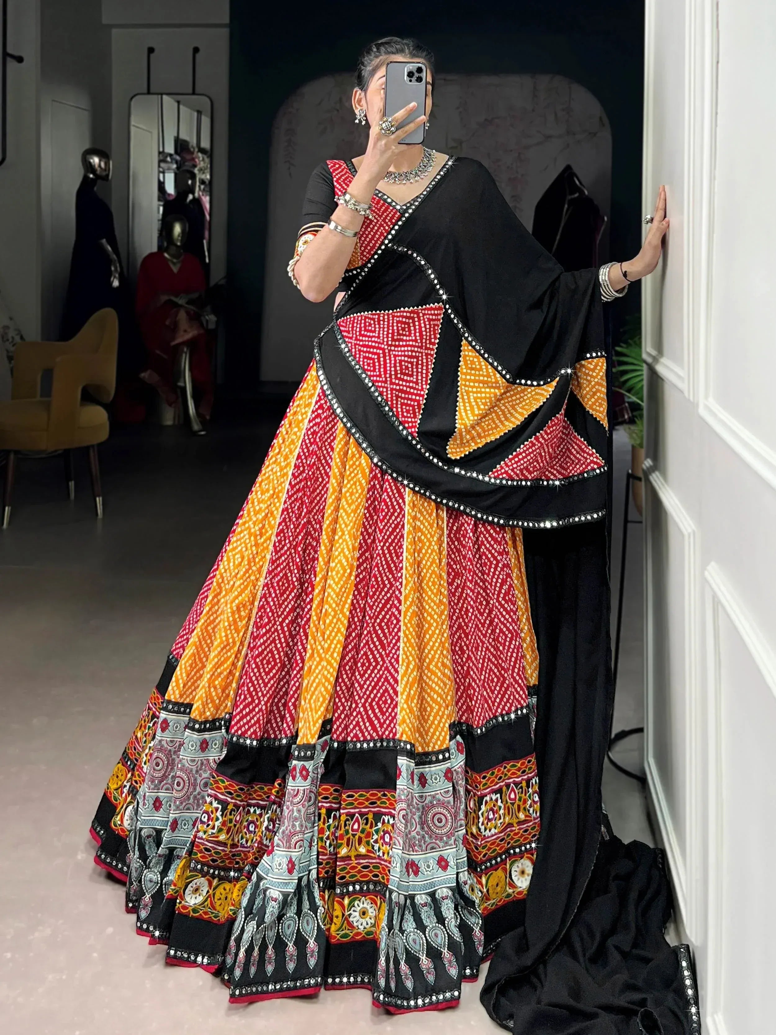 Vibrant red and orange printed lehenga choli with black dupatta, perfect for Indian ethnic wear.