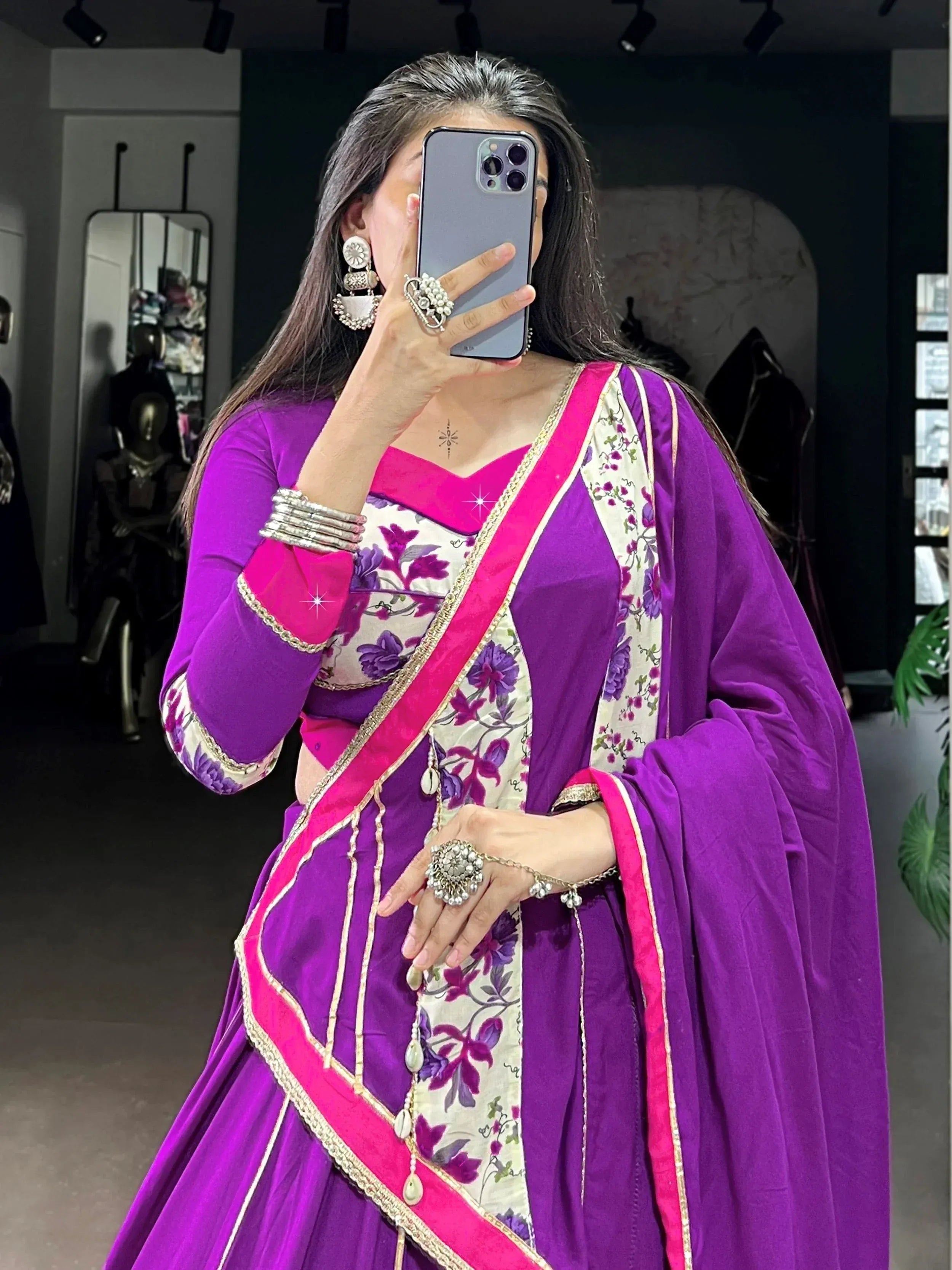 Purple and pink floral Indian ethnic lehenga choli with gold trim, styled with traditional jewelry