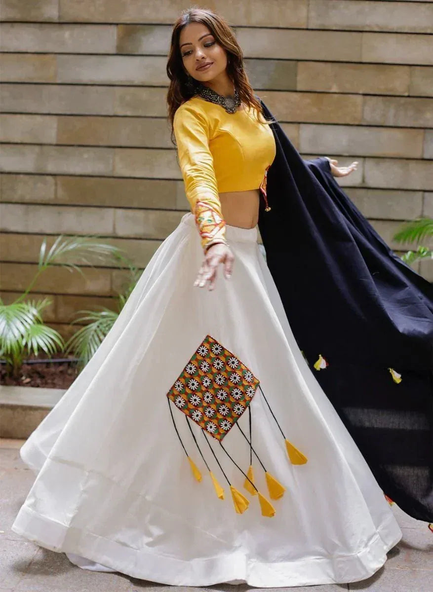 Yellow crop top with white lehenga featuring kite embroidery, paired with black dupatta for Indian ethnic wear