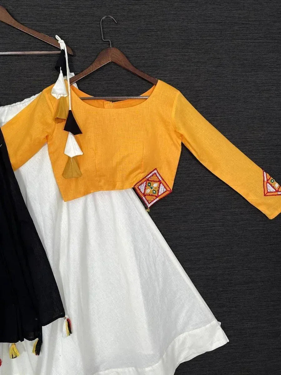 Yellow and white ethnic gown with embroidered patch and tassels, perfect for festive occasions