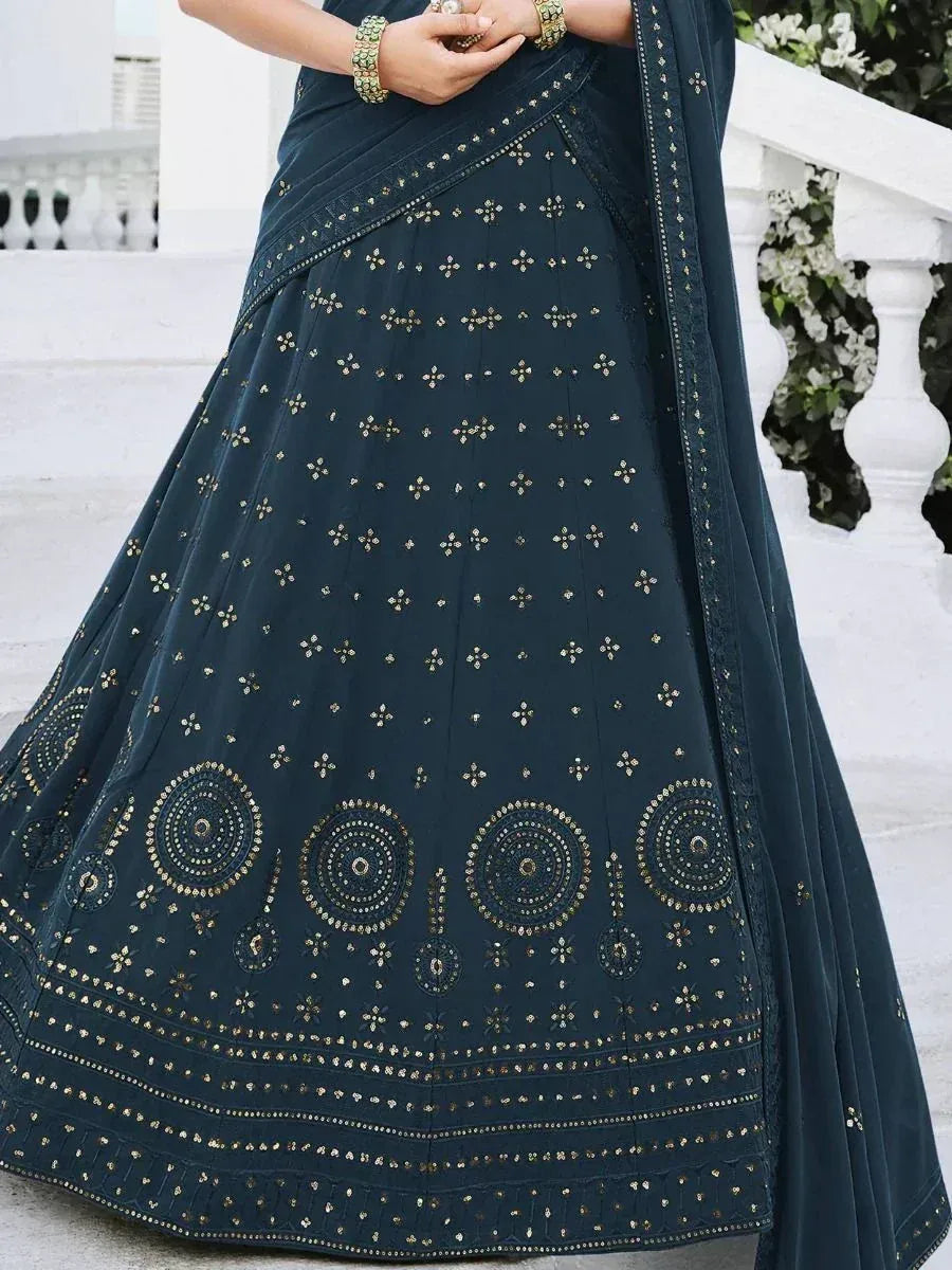Dark teal lehenga choli with gold mirror work and circular embroidery, perfect for Indian ethnic occasions