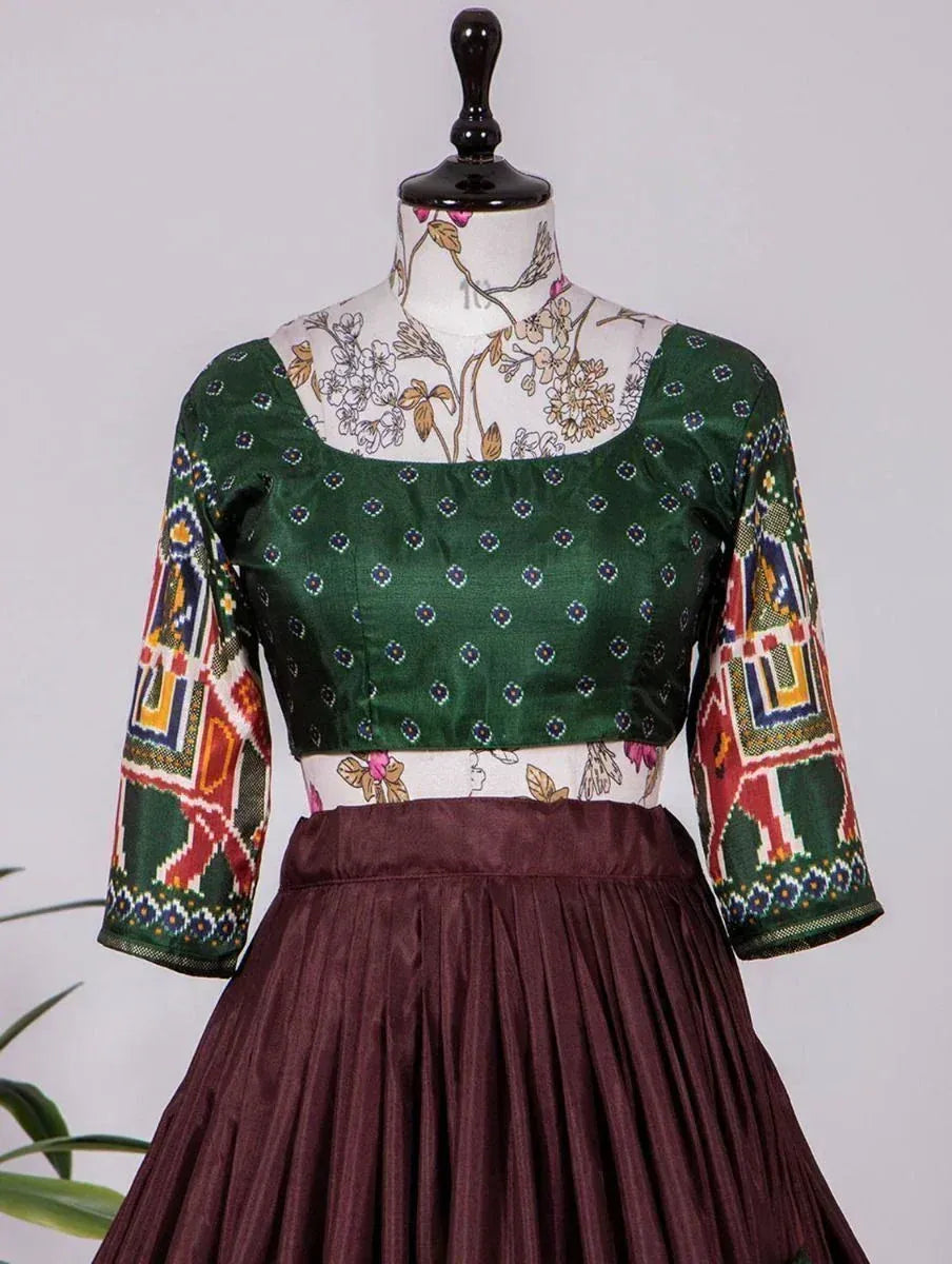 Green printed blouse with colorful sleeves paired with maroon pleated skirt, ethnic wear