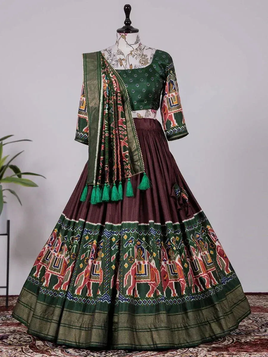 Green and maroon ethnic lehenga choli with elephant print and tassels, perfect for Indian festivals and weddings