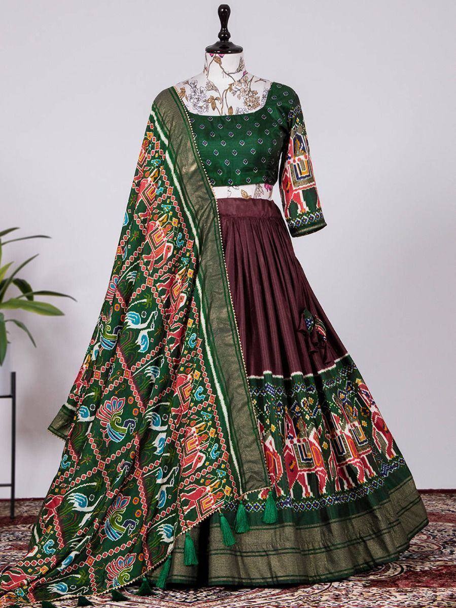 Green and maroon printed lehenga choli with elephant motifs and tassels, ethnic Indian wear