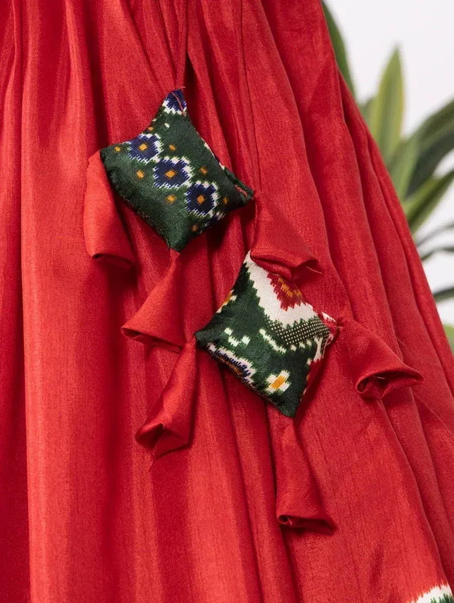 Red ethnic gown with embroidered patch details, perfect for Indian festive wear
