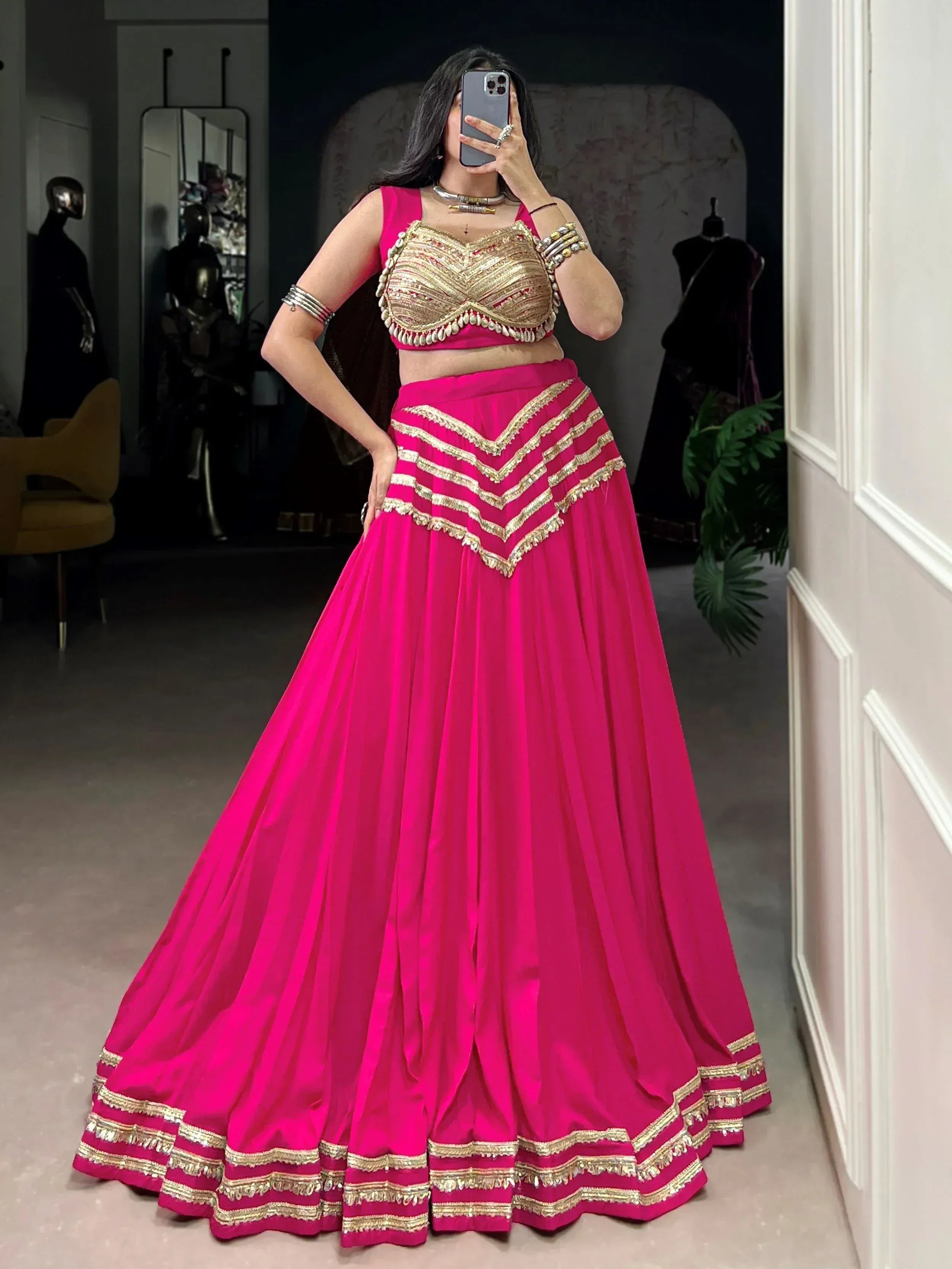 Fuchsia lehenga choli with gold embroidery, perfect for Indian weddings and festive occasions.