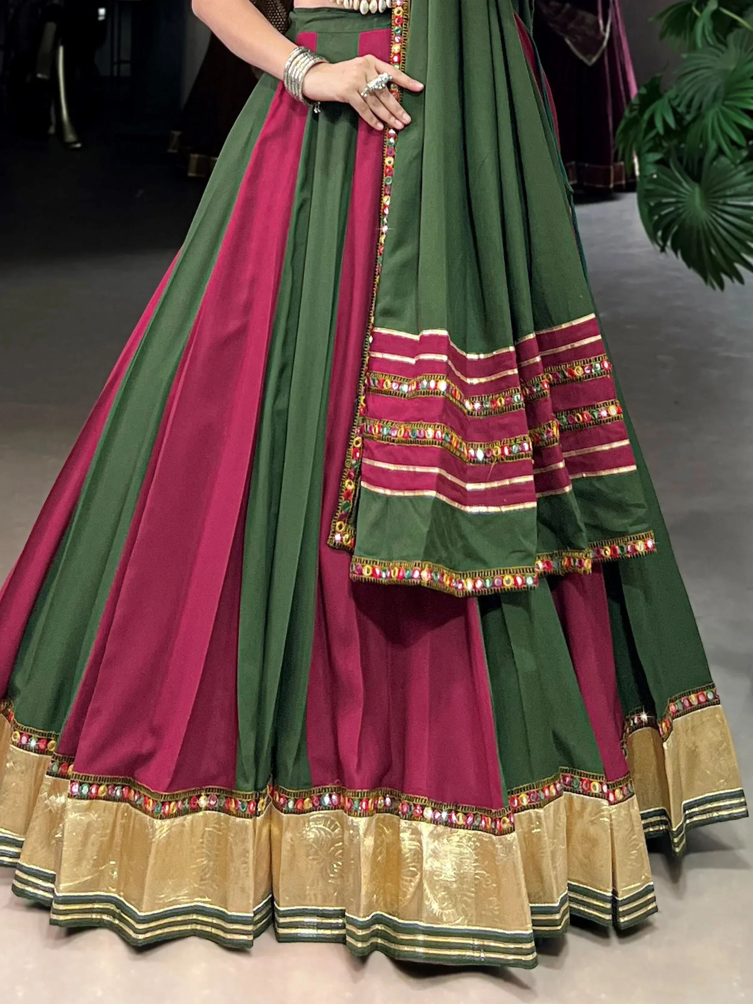 Green and maroon Indian lehenga choli with mirror work and gold border, ethnic wear for women