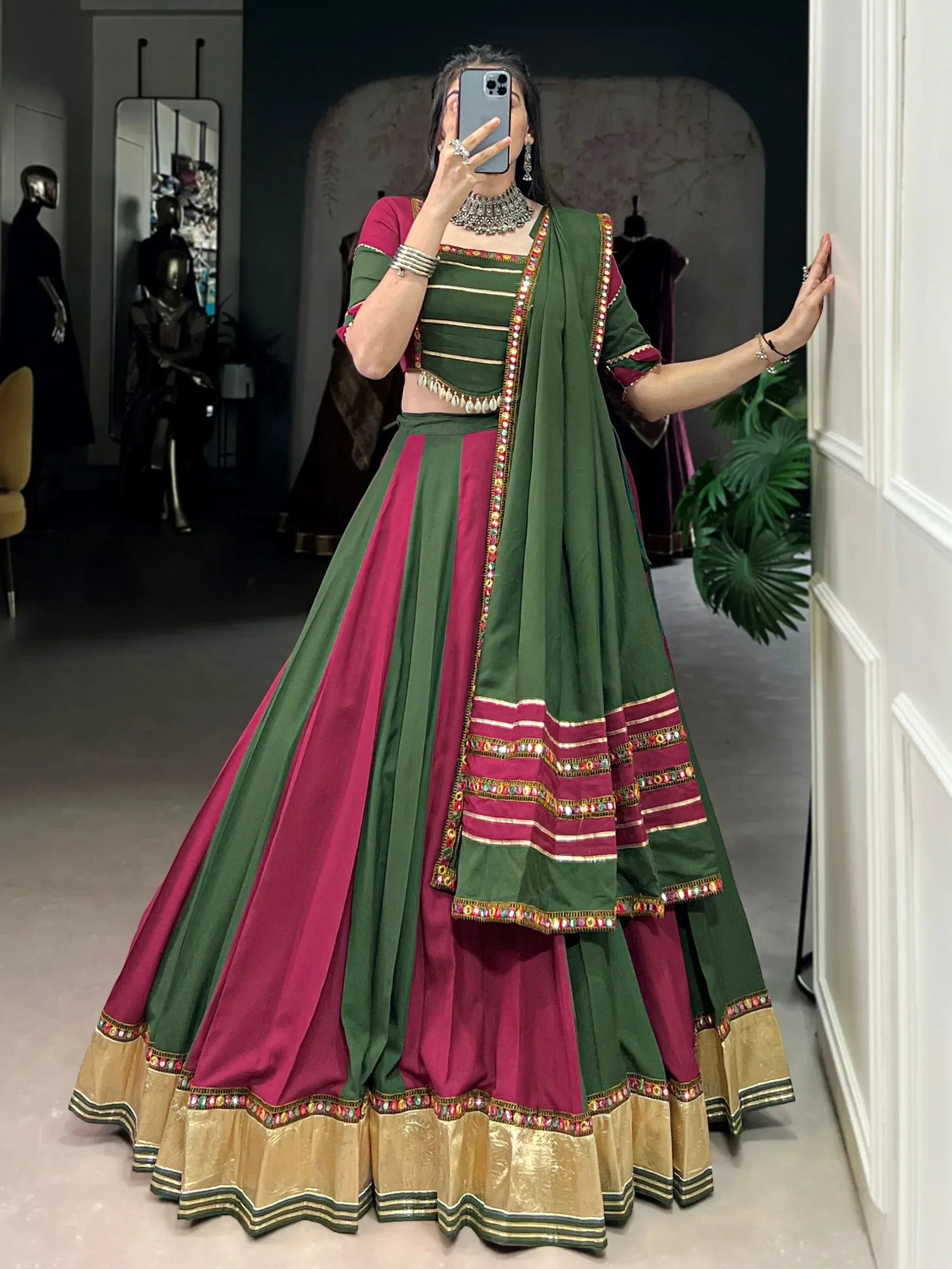 Green and maroon designer lehenga choli with mirror work, perfect for Indian ethnic wear occasions.