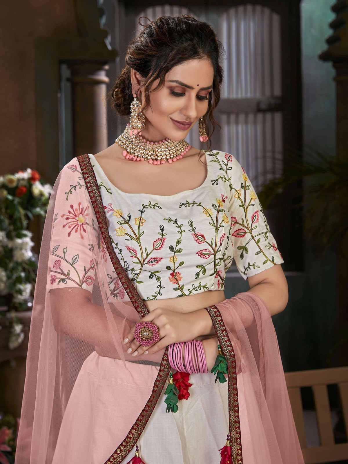 Floral embroidered white and pink Indian ethnic lehenga choli with matching dupatta and jewelry