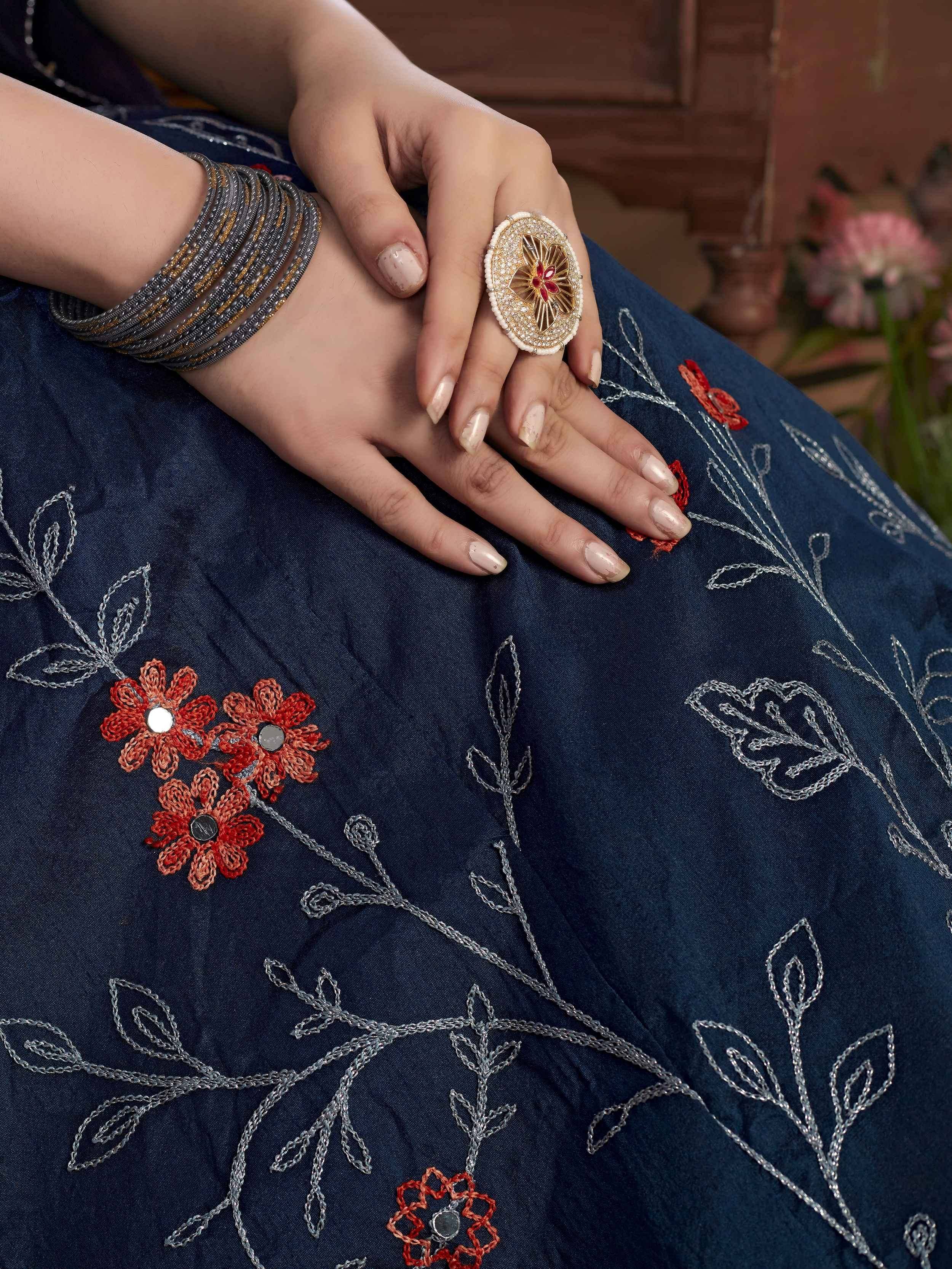 Blue embroidered ethnic gown with floral design, statement ring, and bangles for Indian wear