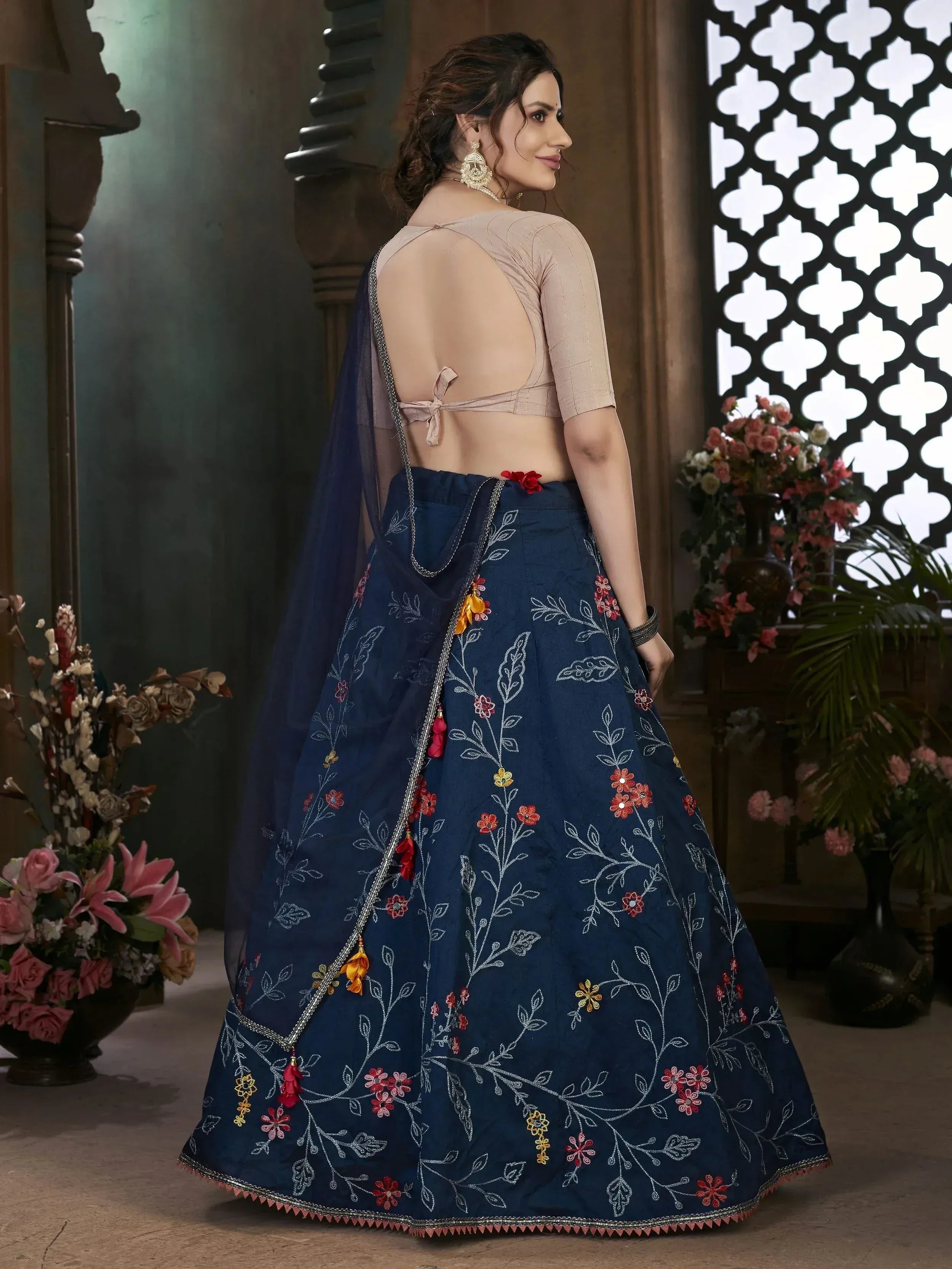 Navy blue embroidered lehenga choli with floral design and backless blouse, perfect for Indian ethnic occasions.
