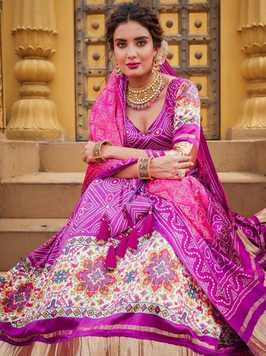 Vibrant pink and purple printed lehenga choli with gold jewelry, perfect for Indian ethnic occasions