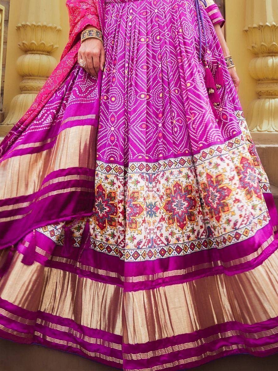 Vibrant pink and gold ethnic lehenga with intricate floral and geometric prints, perfect for Indian weddings and festivals.