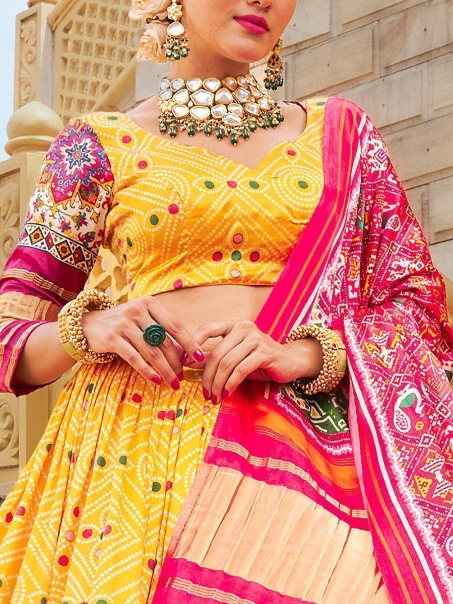 Vibrant yellow and pink ethnic lehenga choli with mirror work, perfect for festive occasions