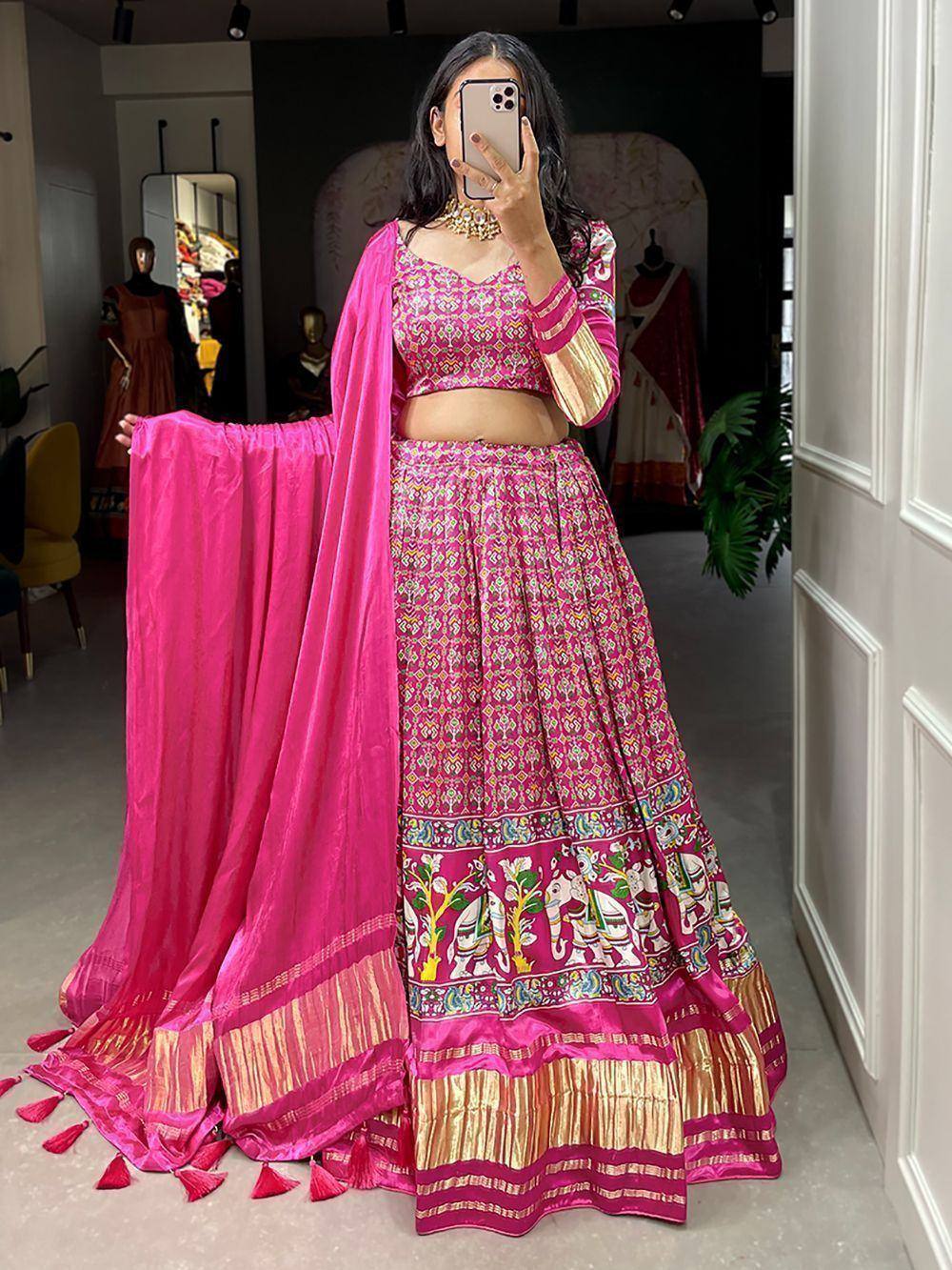 Pink printed lehenga choli with elephant motifs, gold border, and matching dupatta for ethnic wear