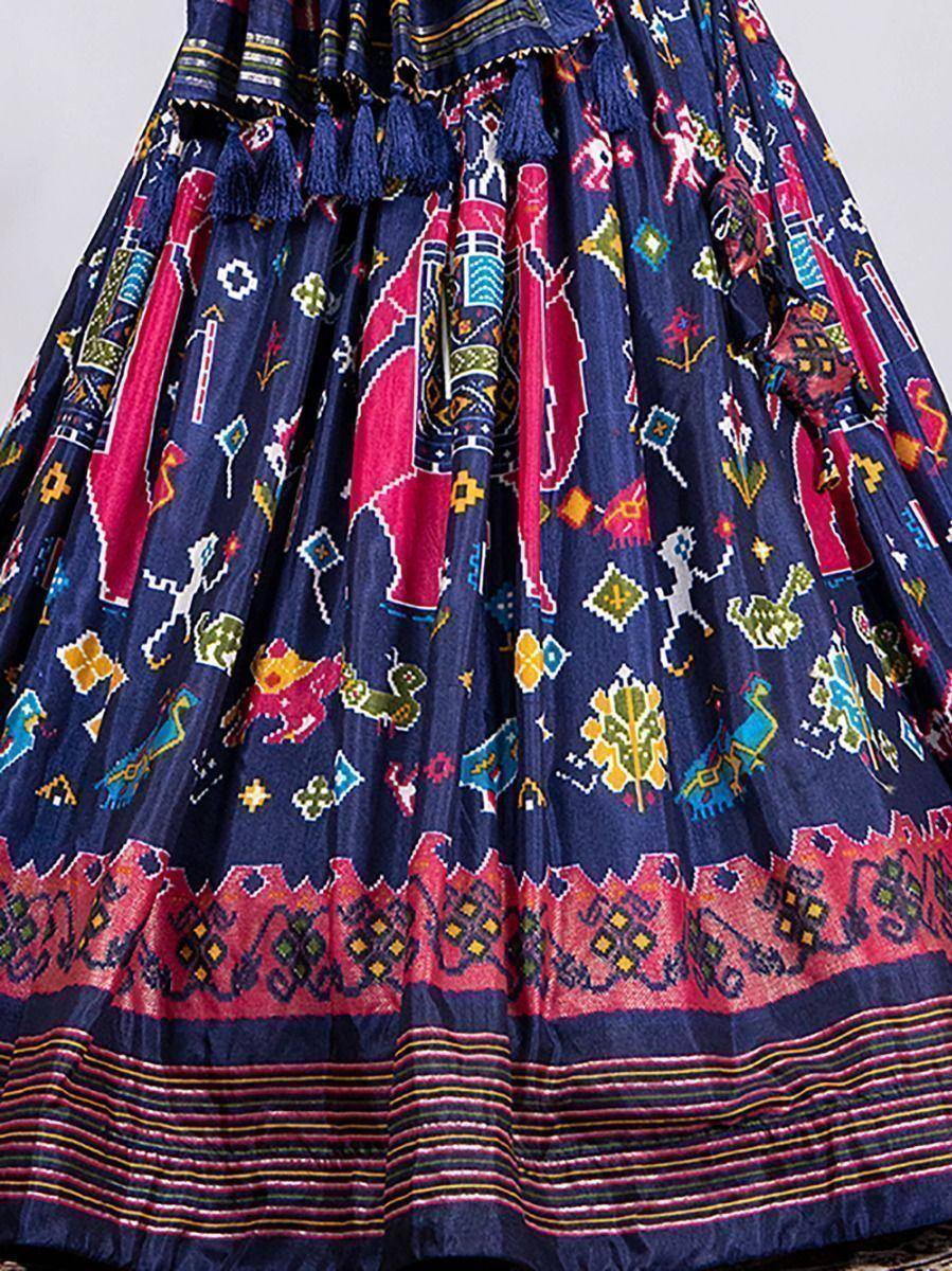 Blue ethnic skirt with vibrant animal & geometric prints, tassels, and border detailing for festive wear