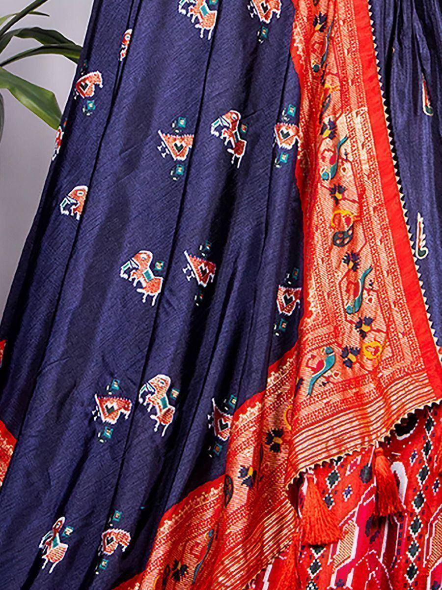 Navy blue ethnic skirt with horse print, paired with vibrant red dupatta featuring folk art motifs and tassels