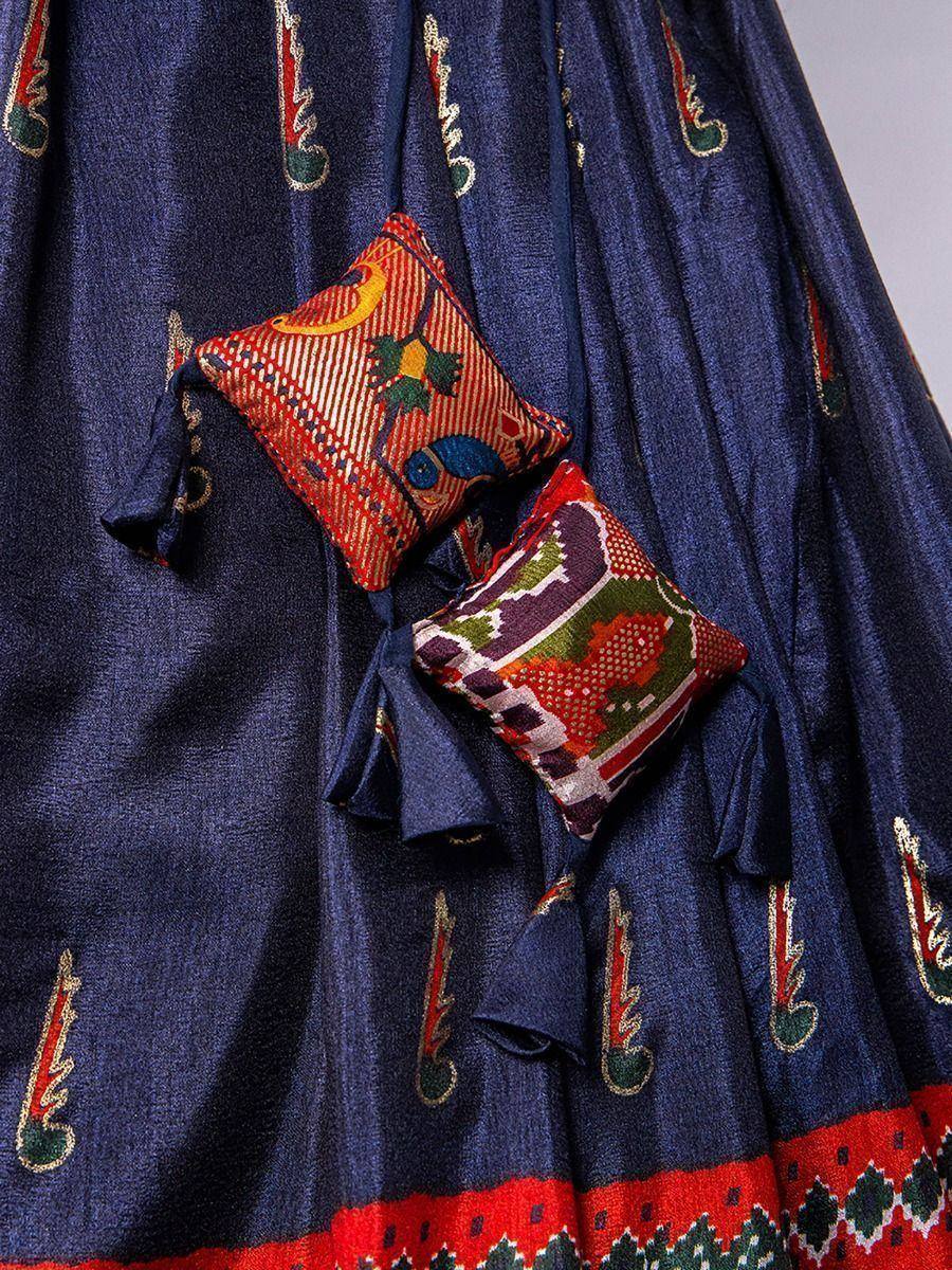 Navy blue ethnic lehenga with colorful embroidered motifs and decorative patch pockets, perfect for festive occasions.