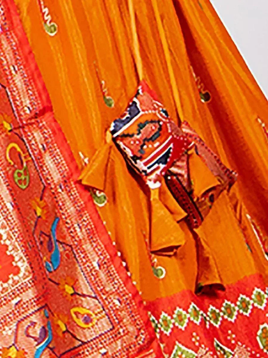 Vibrant orange and red ethnic lehenga choli with intricate embroidery and mirror work details
