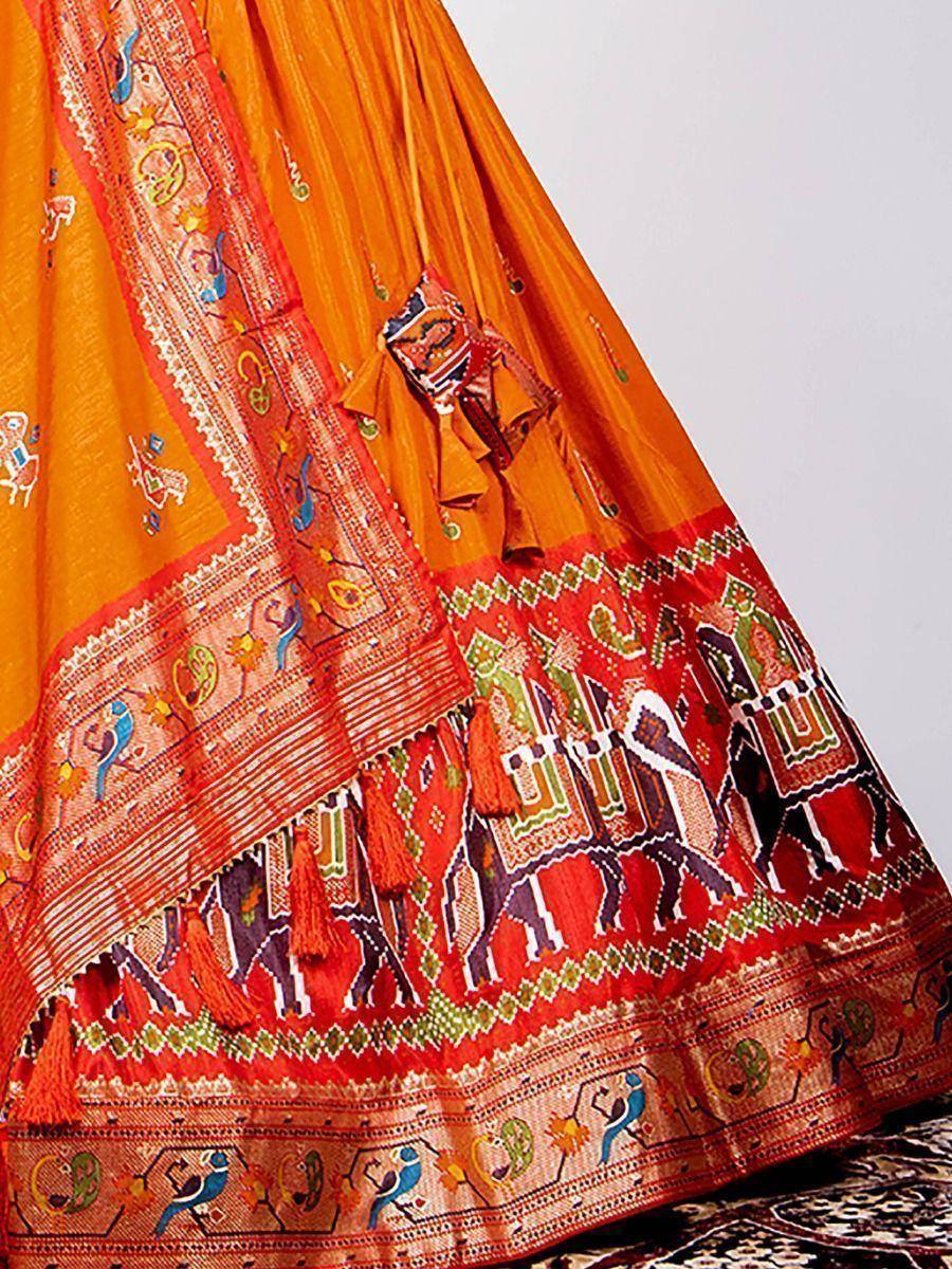 Vibrant orange lehenga with intricate elephant and bird embroidery, perfect for Indian ethnic wear