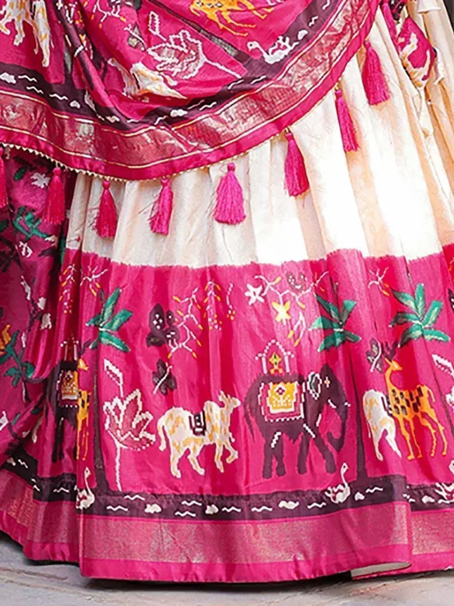 Pink and cream ethnic lehenga with animal print, tassels, and traditional Indian motifs for festive wear