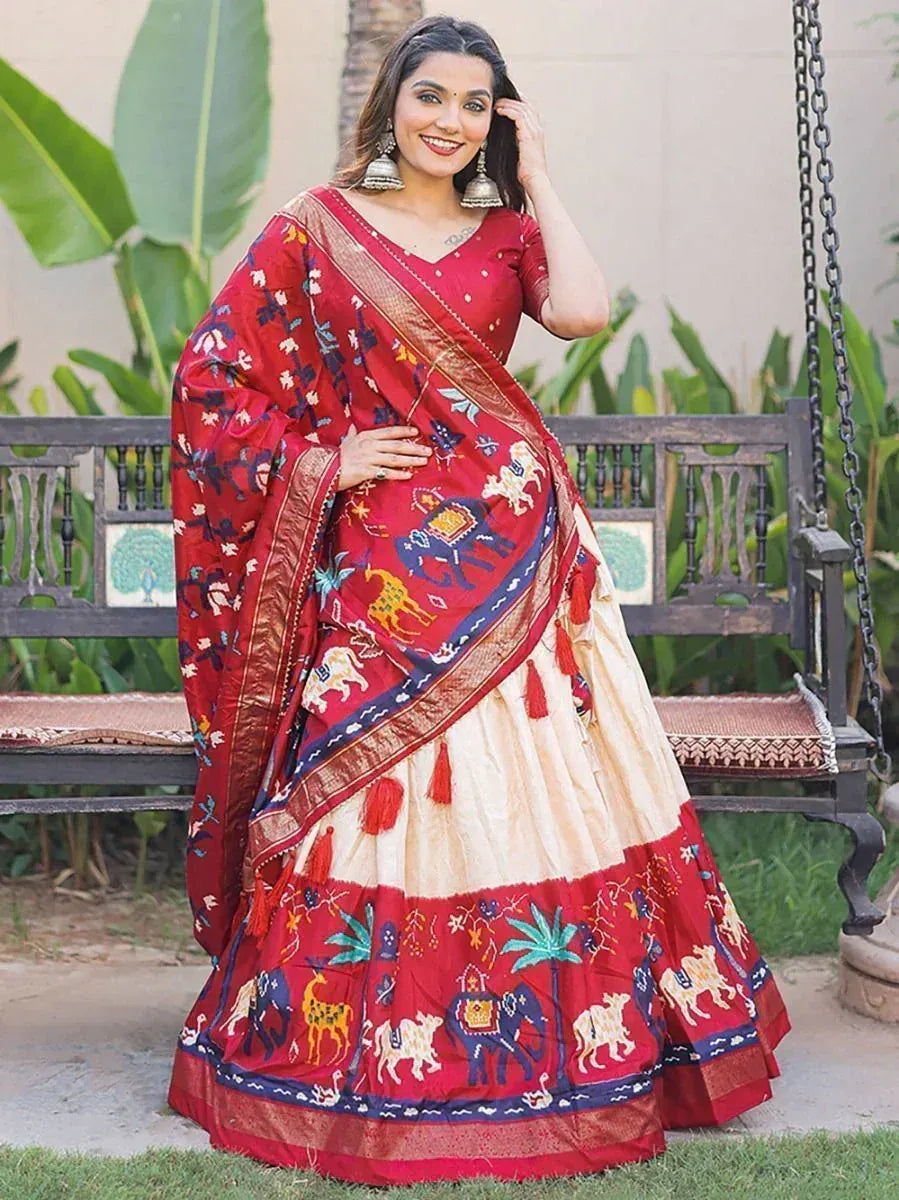 Red and cream embroidered lehenga choli with elephant motifs, perfect for Indian ethnic wear occasions