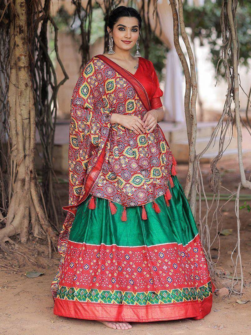 Vibrant red and green printed lehenga choli with tassels, perfect for Indian ethnic occasions