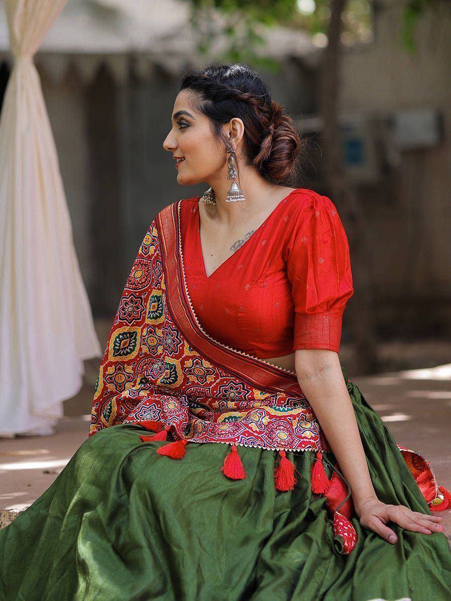 Woman in red blouse and green lehenga with colorful printed dupatta, ethnic Indian wear