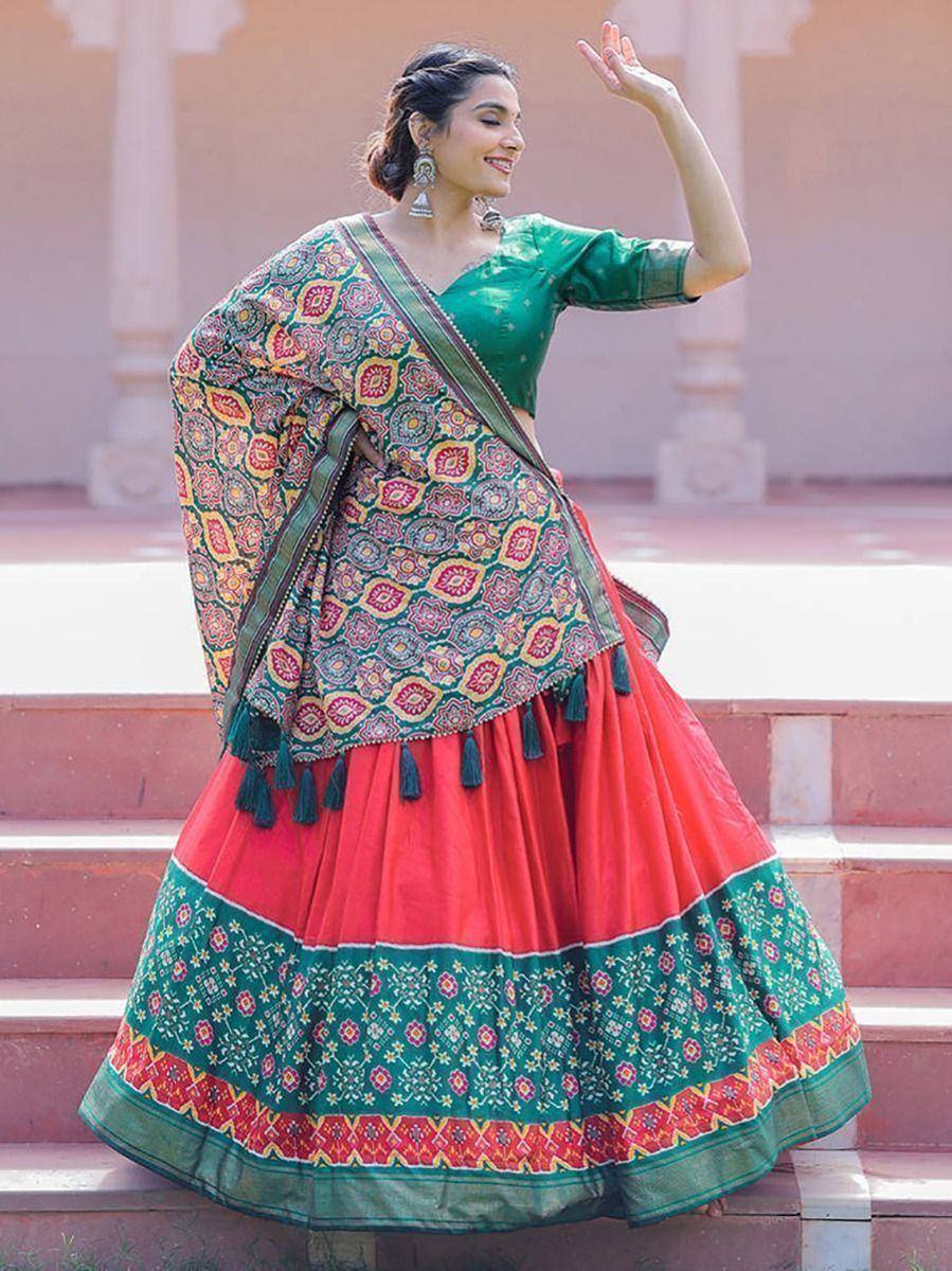Woman in vibrant green and red lehenga choli with floral dupatta, perfect for Indian ethnic wear occasions
