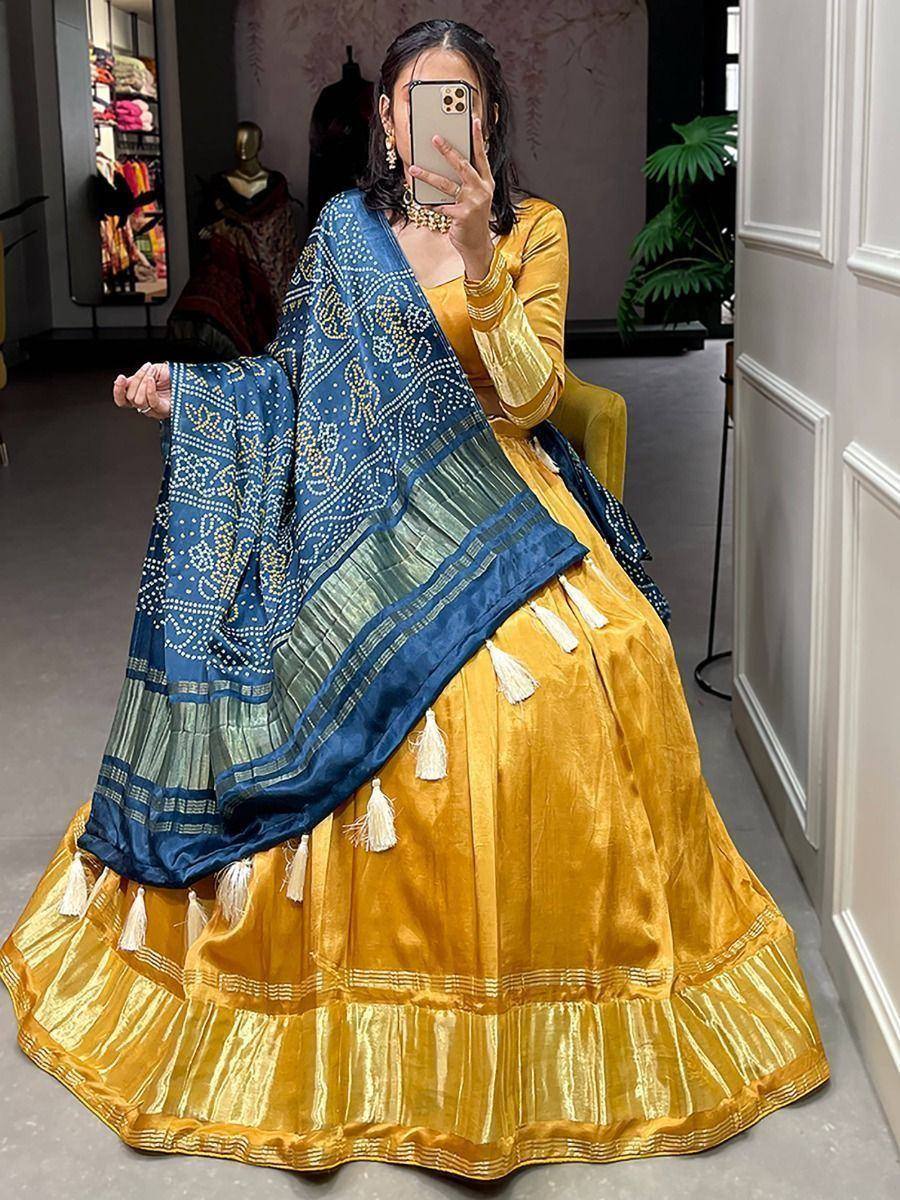 Mustard yellow lehenga choli with blue embroidered dupatta, tassels, and velvet blouse for Indian ethnic wear