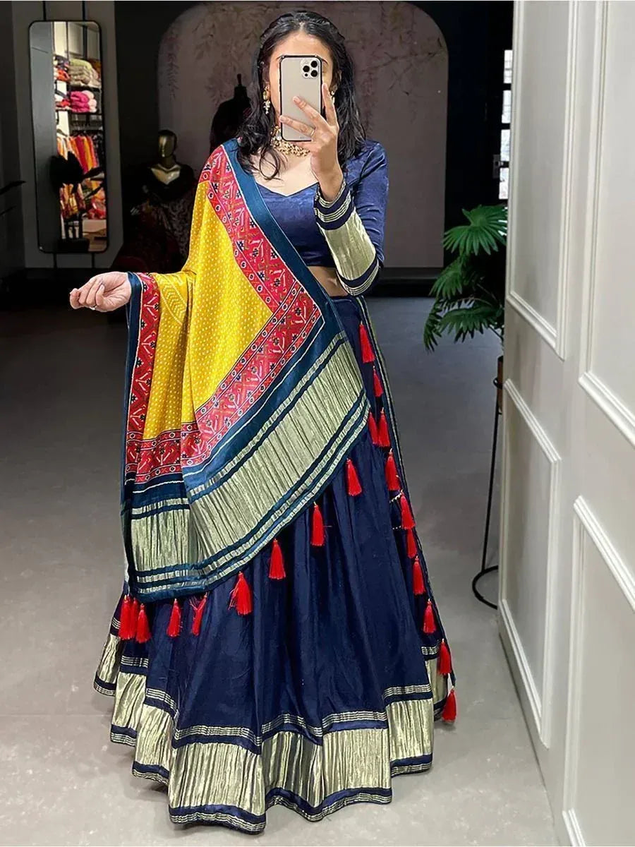 Navy blue lehenga choli with yellow red dupatta, tassels, and gold trim, perfect for Indian ethnic wear