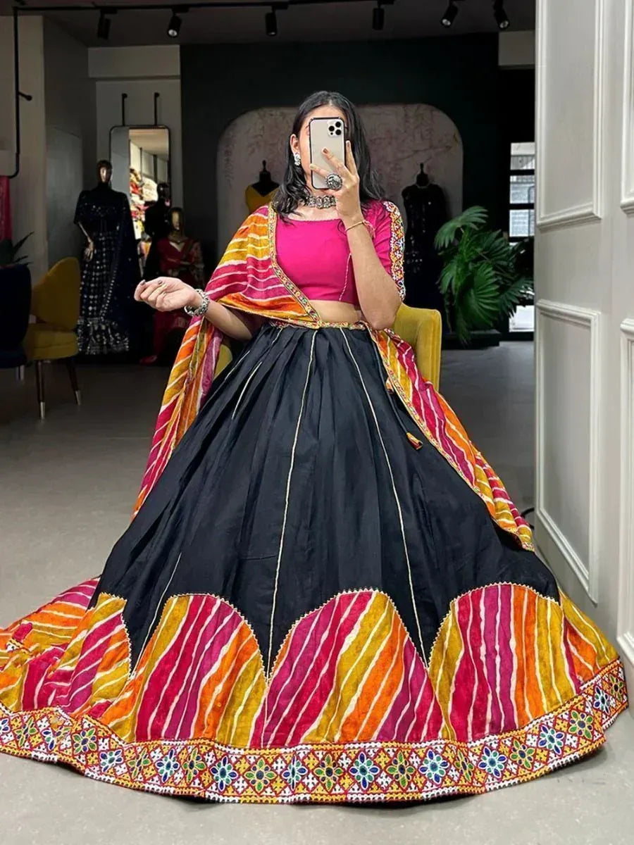 Black lehenga with vibrant pink and orange striped border, paired with matching dupatta and crop top