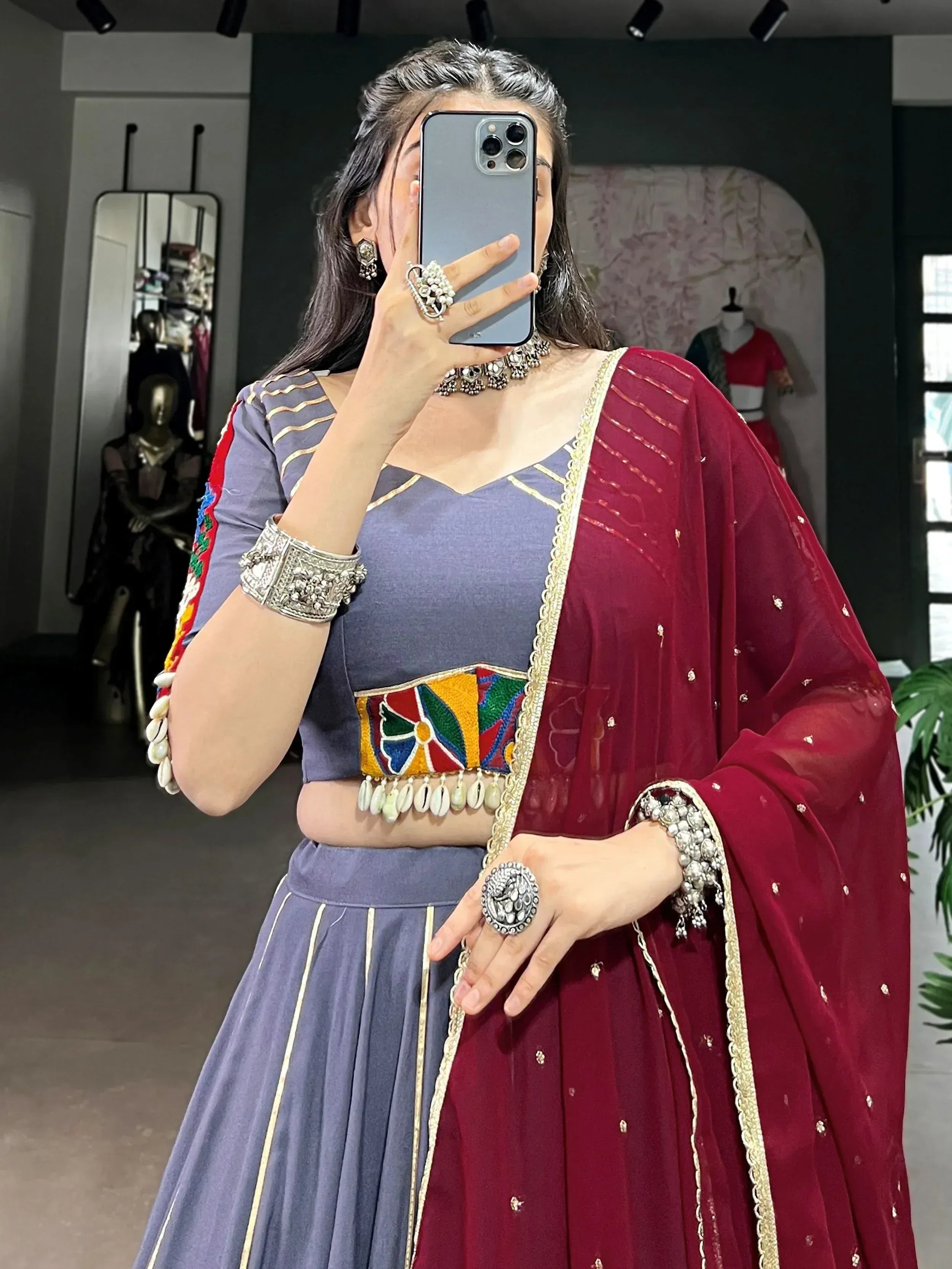 Woman in purple embroidered lehenga with maroon dupatta, traditional Indian ethnic wear, mirror selfie