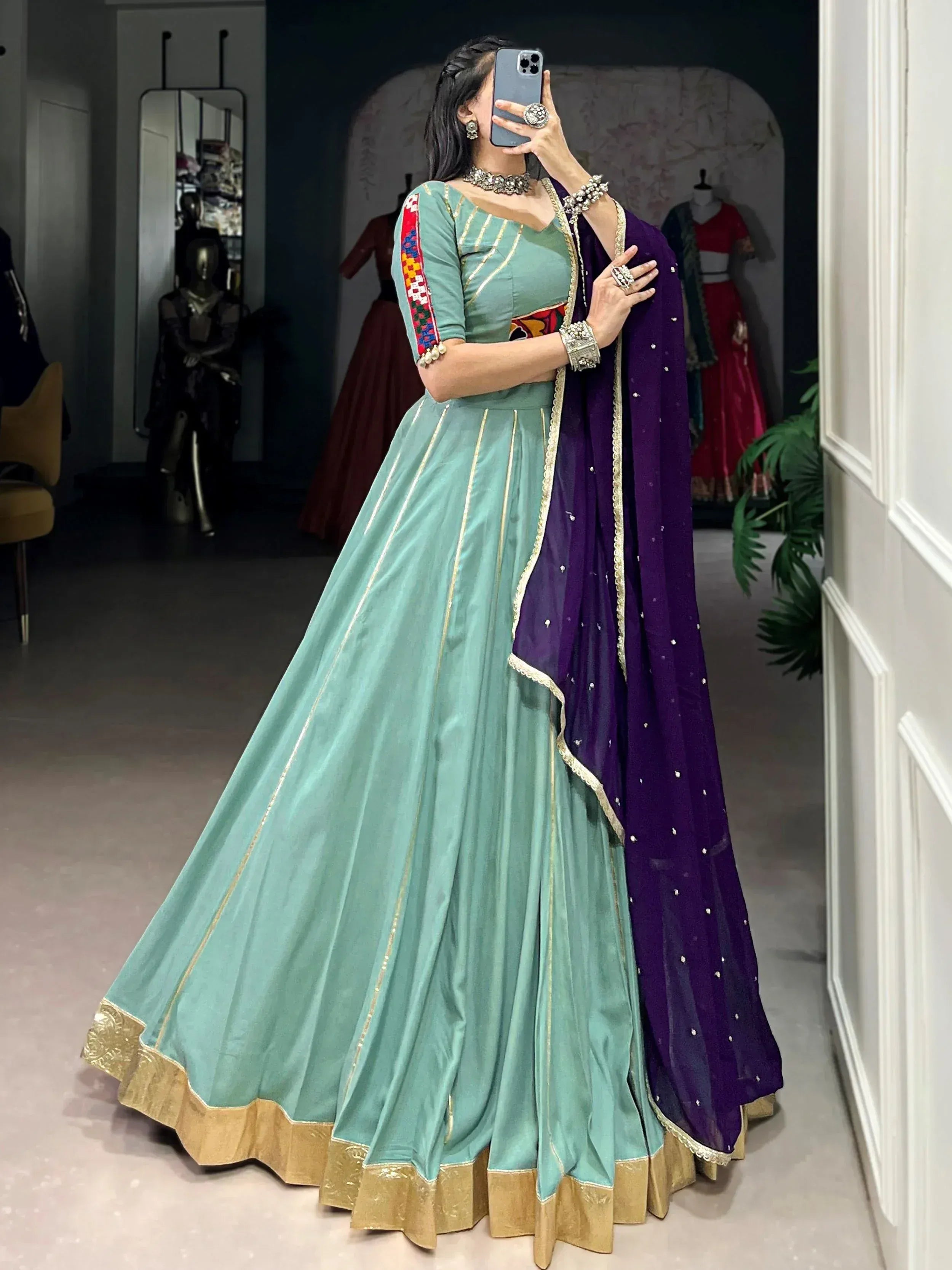 Mint green lehenga choli with gold trim and purple dupatta, perfect for Indian ethnic wear