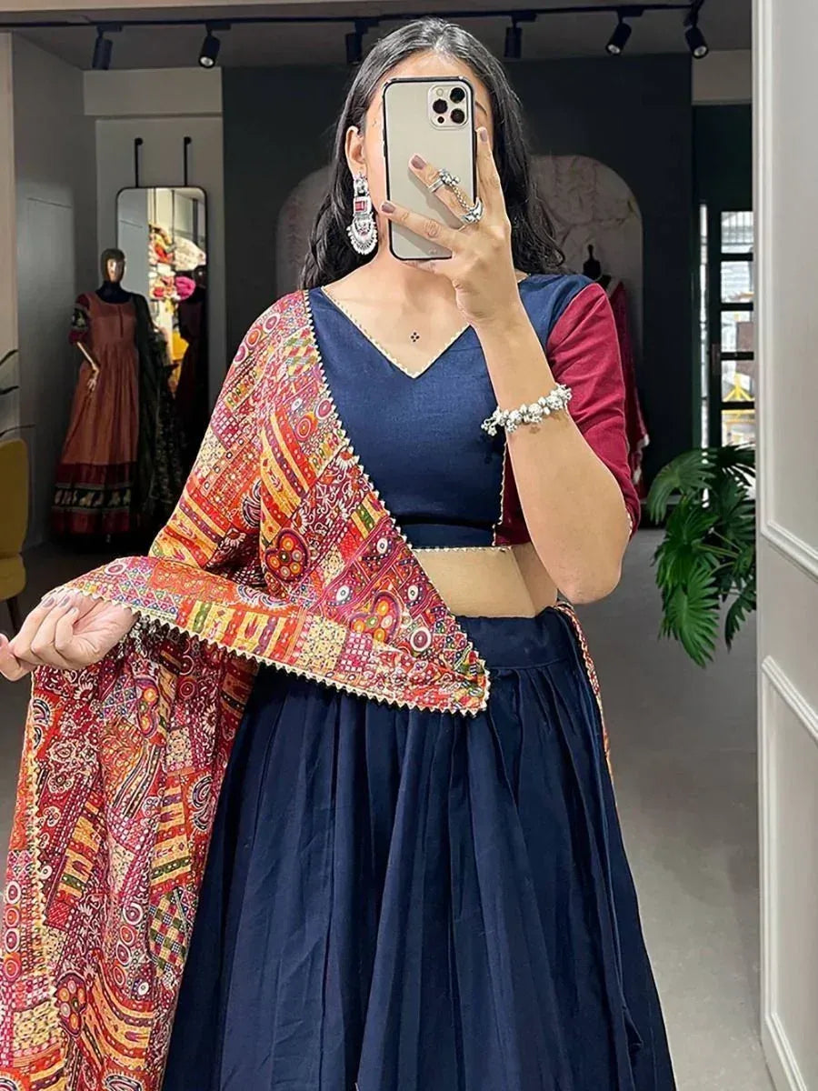 Woman in navy blue lehenga choli with colorful embroidered dupatta, ethnic Indian wear