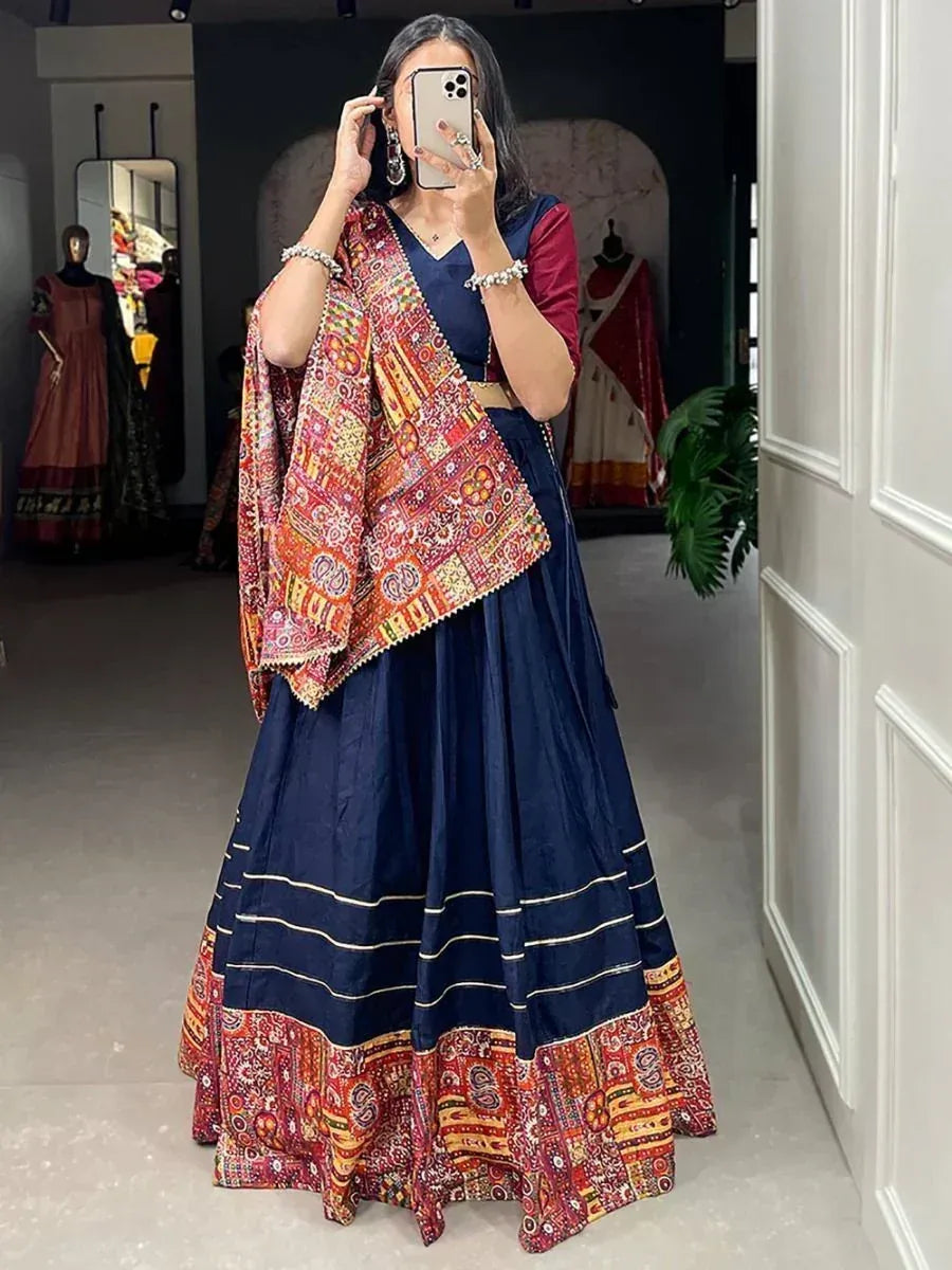 Woman in navy blue lehenga choli with colorful printed dupatta, ethnic Indian wear