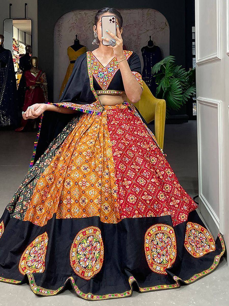 Colorful embroidered lehenga choli with black dupatta, vibrant orange and red patterns, perfect for Indian ethnic occasions