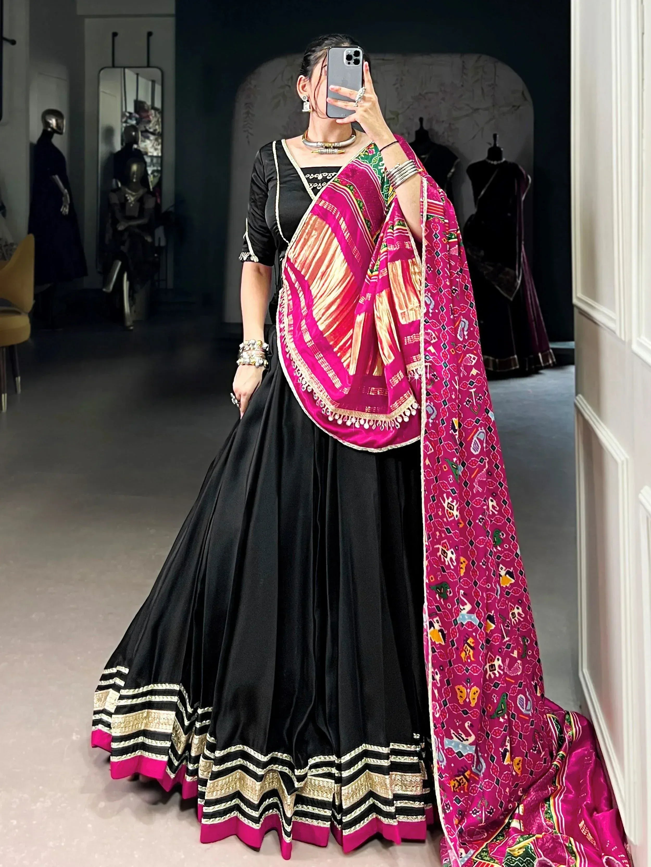 Black lehenga choli with vibrant pink printed dupatta, ethnic Indian wear for festive occasions