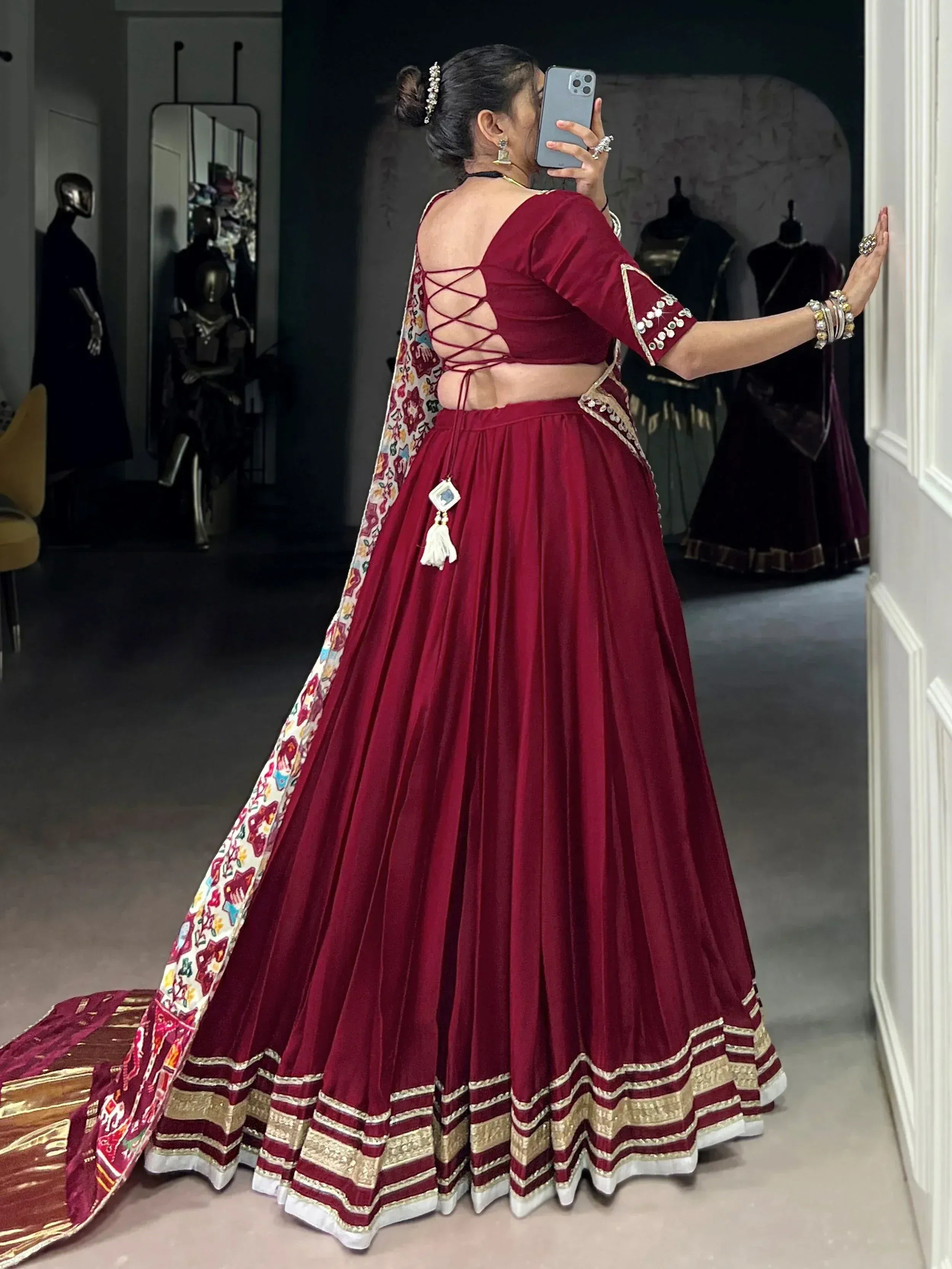Maroon velvet lehenga choli with back lace-up design, embroidered dupatta, and gold trim