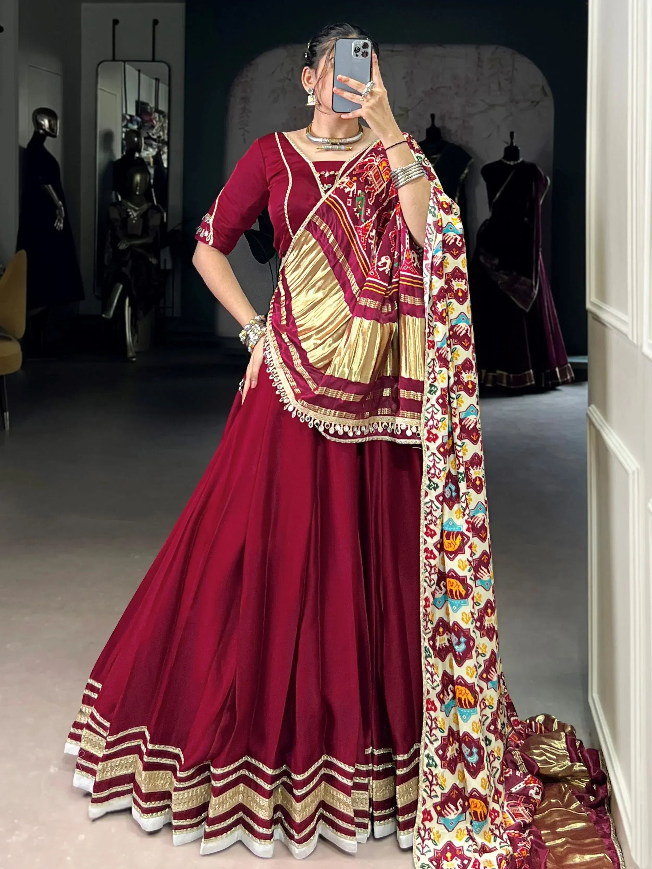 Maroon ethnic lehenga choli with gold embroidery and printed dupatta, perfect for Indian weddings and festive occasions.