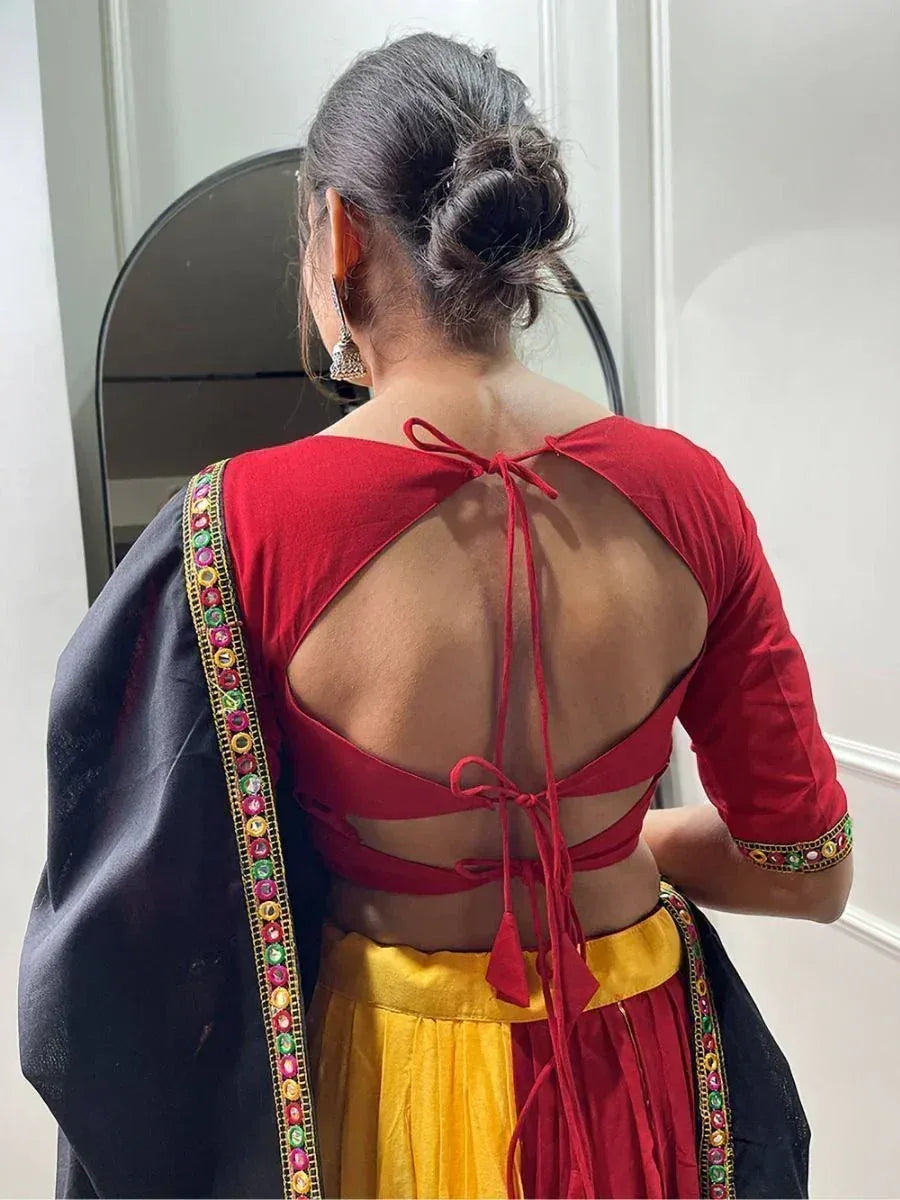 Red backless blouse with tie-up detail, yellow skirt, and embroidered black dupatta for Indian ethnic wear