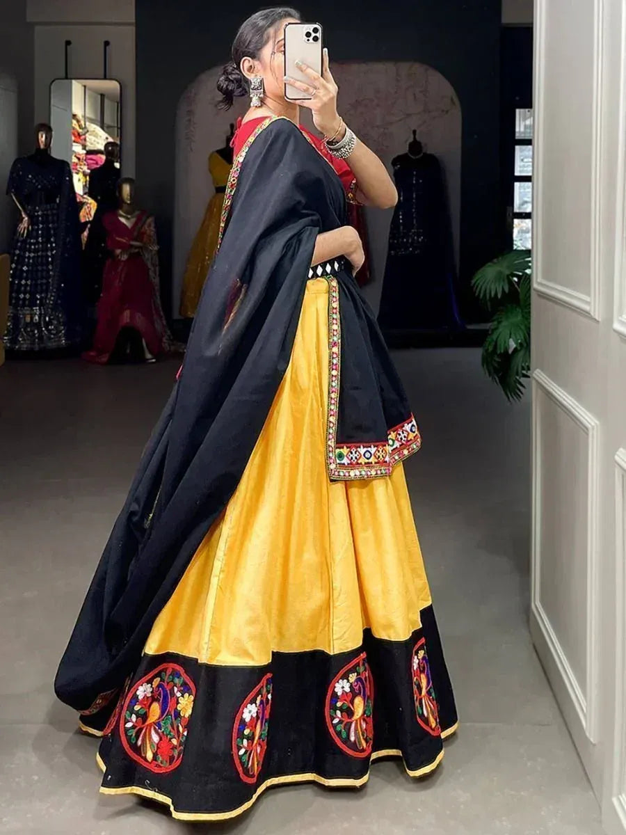 Yellow and black embroidered lehenga choli with mirror work, perfect for Indian ethnic wear occasions