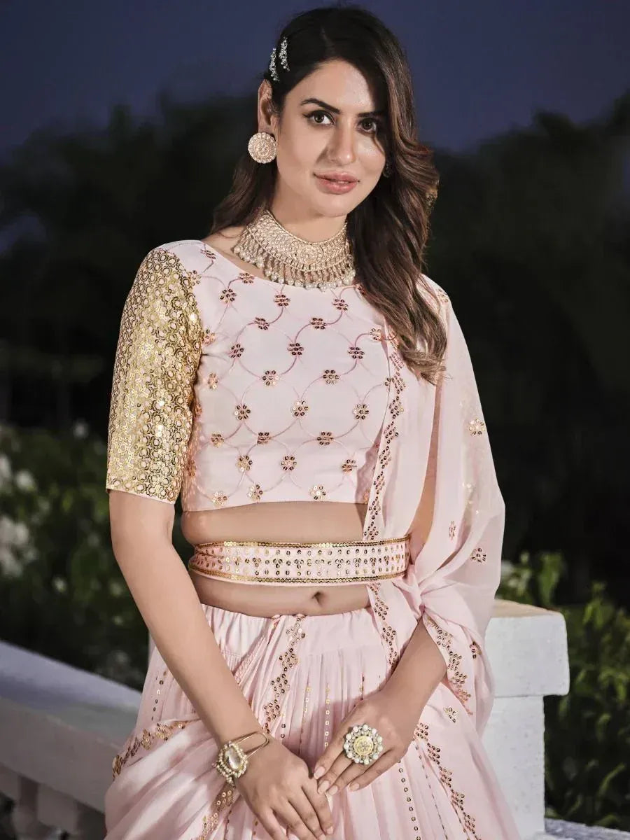 Pink embroidered lehenga choli with gold sequin sleeves, perfect for Indian weddings and festive occasions