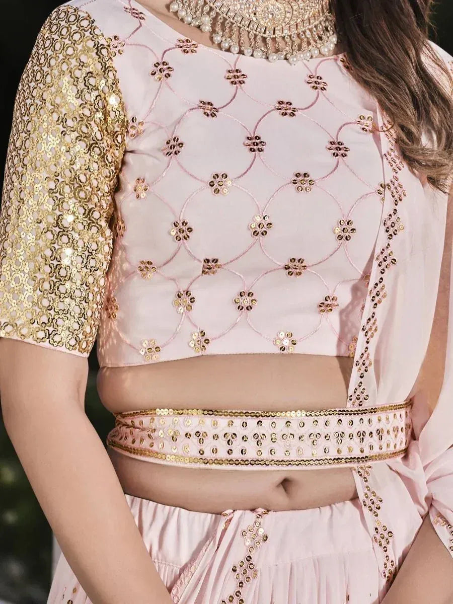 Pink embroidered lehenga choli with gold sequin sleeves and waistband, perfect for Indian ethnic wear